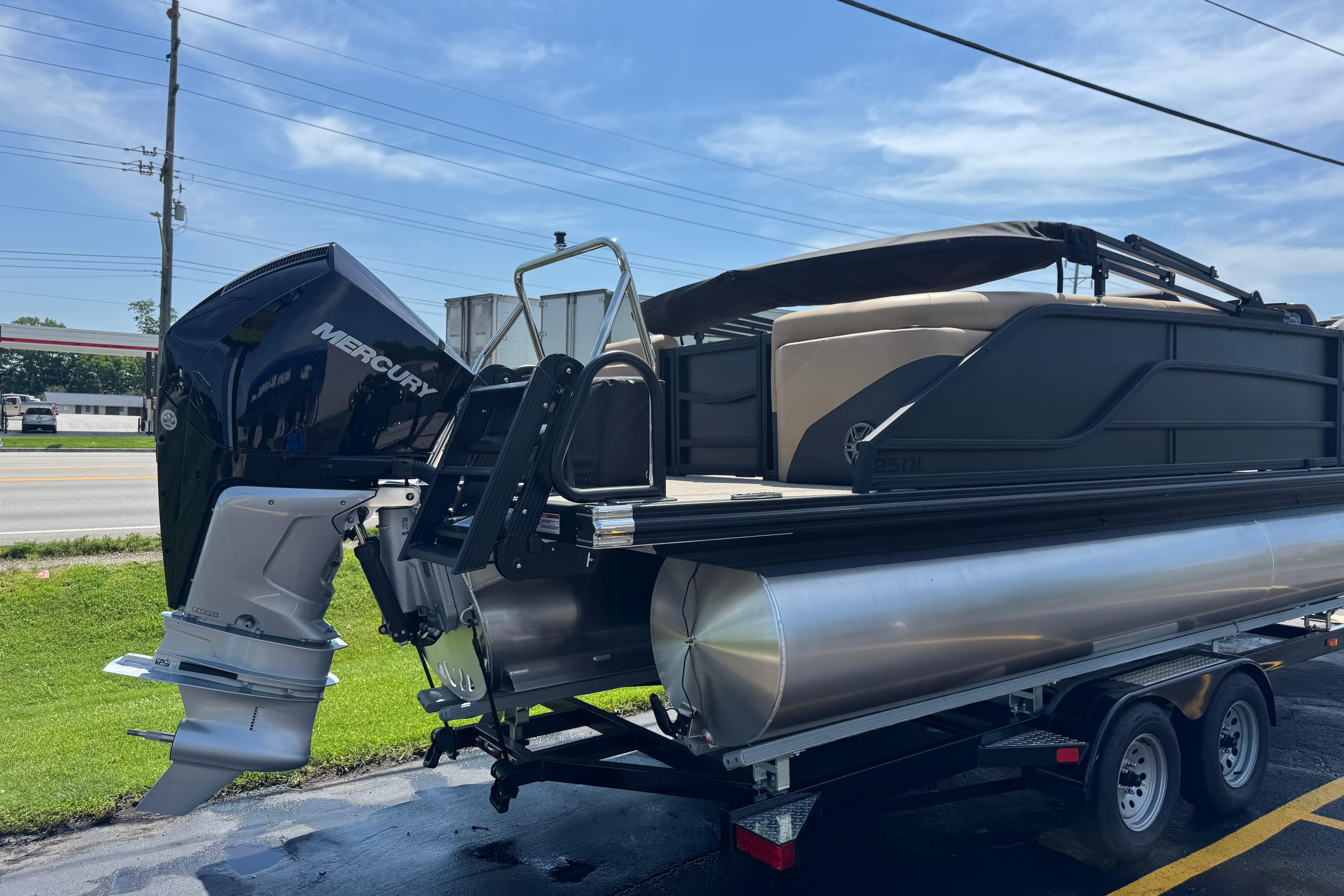 2026 Evotti 525QL pontoon boat with Mercury outboard motor on trailer.
