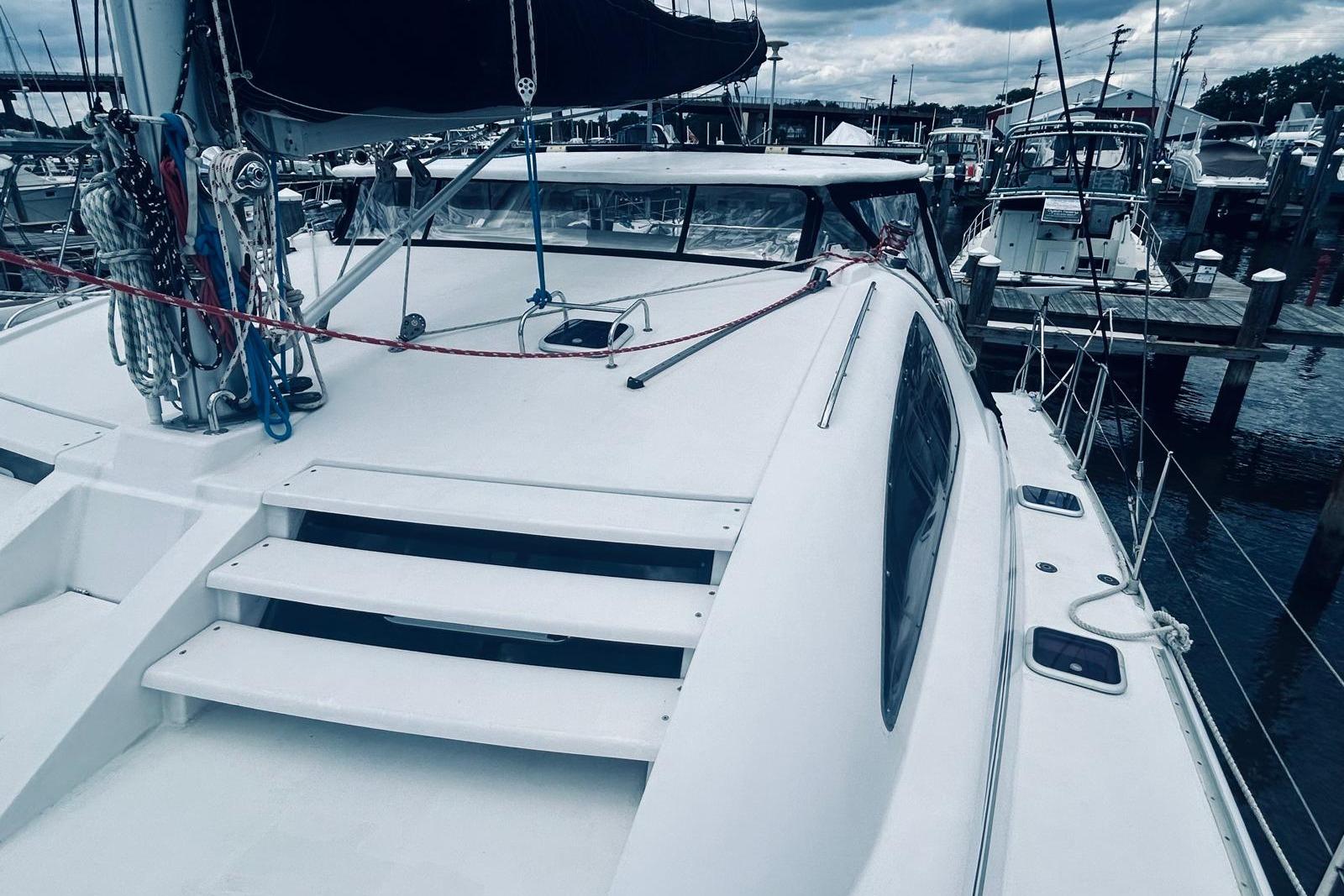 2001 Robertson & Caine Leopard catamaran docked at a marina, showcasing sleek design and rigging.