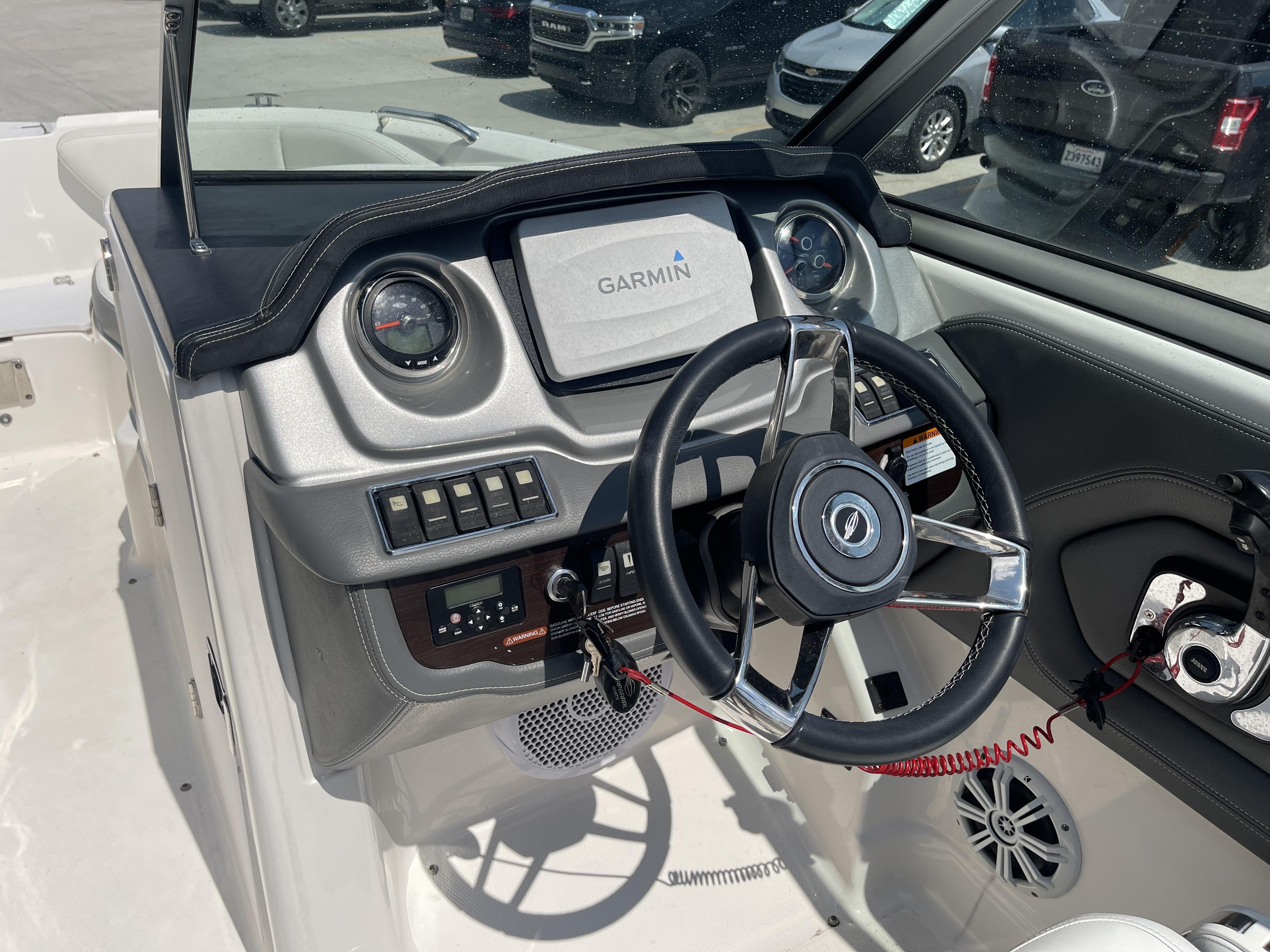 2014 Chaparral Sunesta 224 boat dashboard with Garmin navigation system and steering wheel.