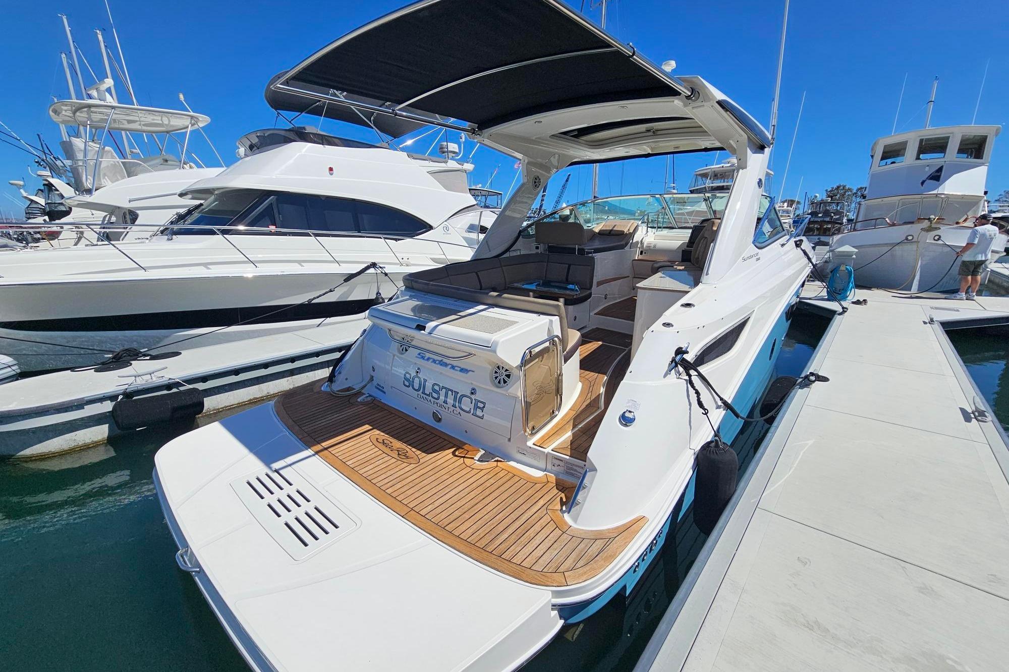 2016 Sea Ray Sundancer 350 yacht docked at marina, showcasing sleek design and spacious deck.