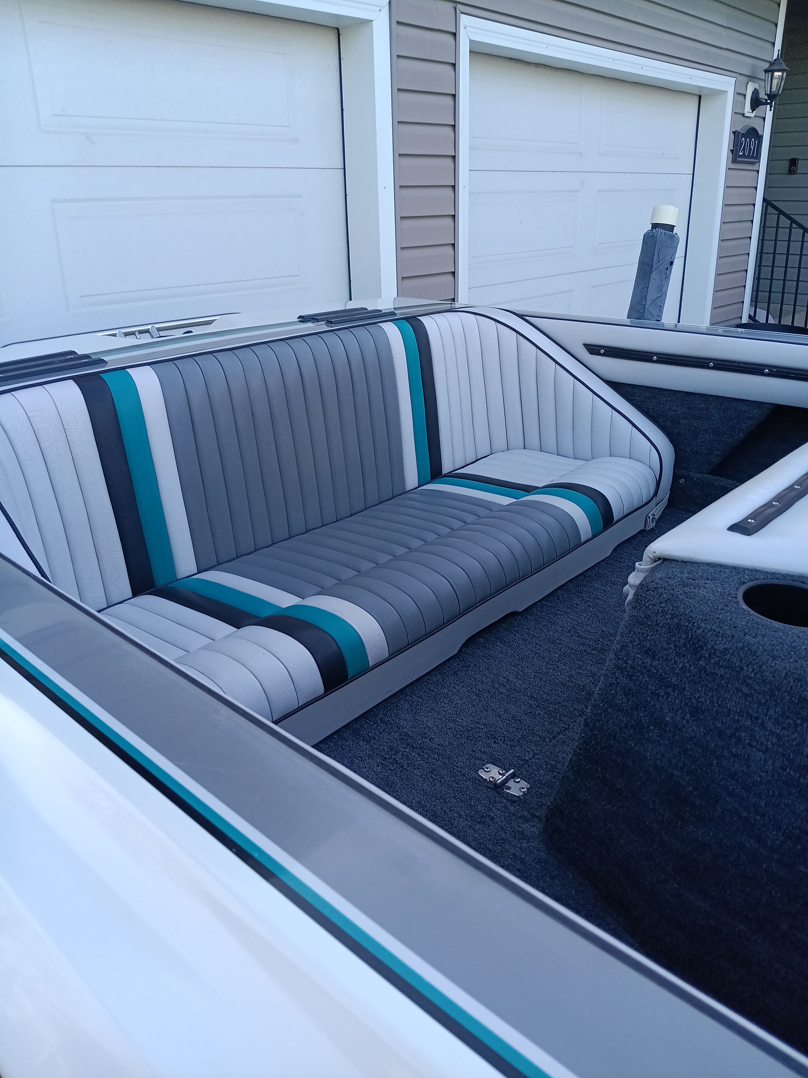 Interior of a 1991 Malibu Skier boat with striped seats.