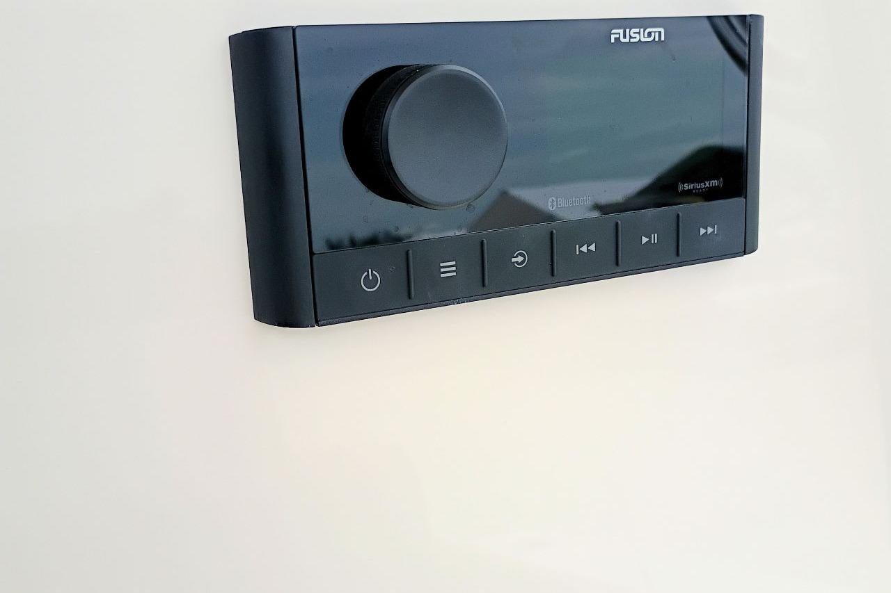 Control panel of a 2027 Pioneer 202 Islander boat featuring Fusion audio system.