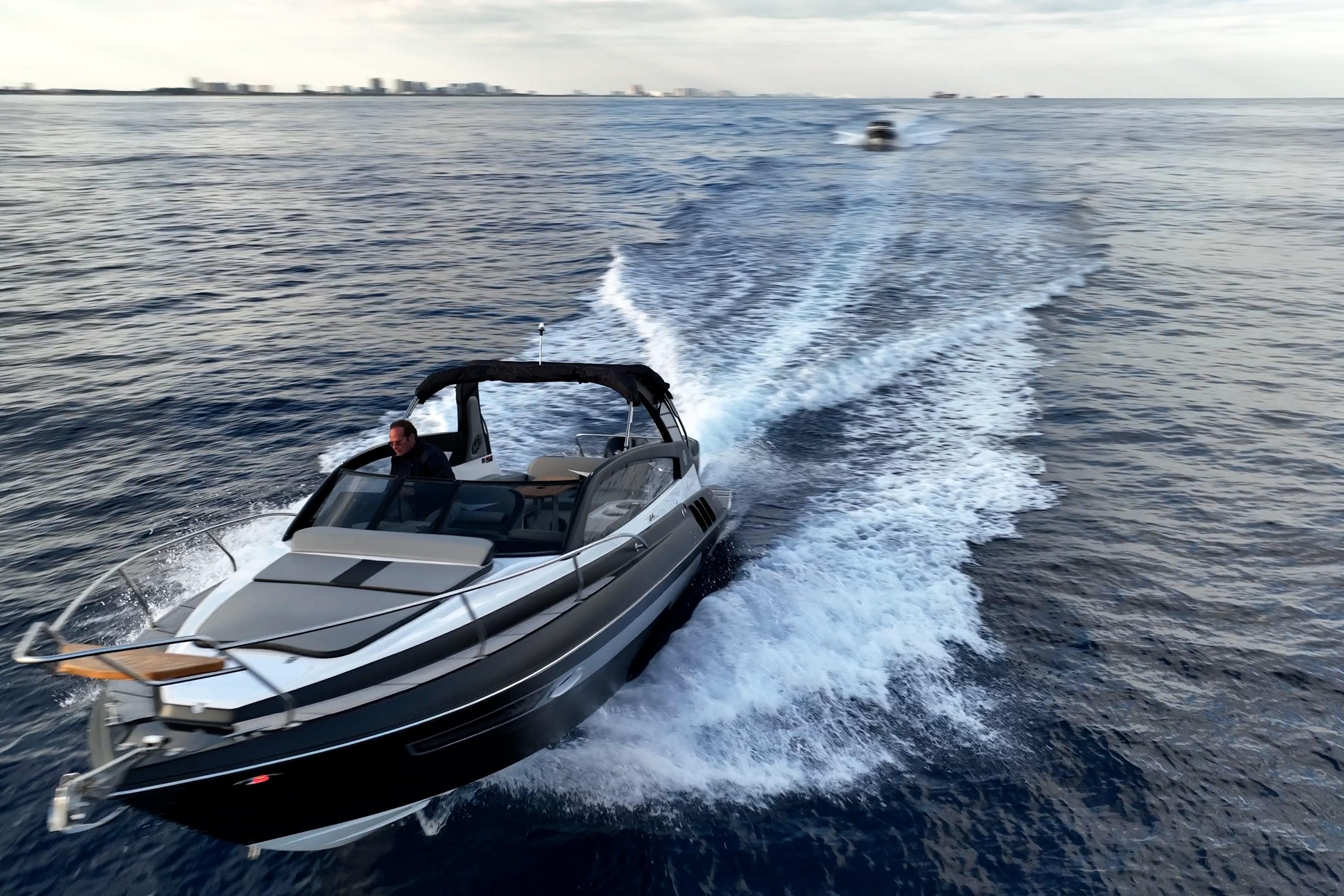 2027 Hanover 305 boat cruising on open water, creating a dynamic wake.