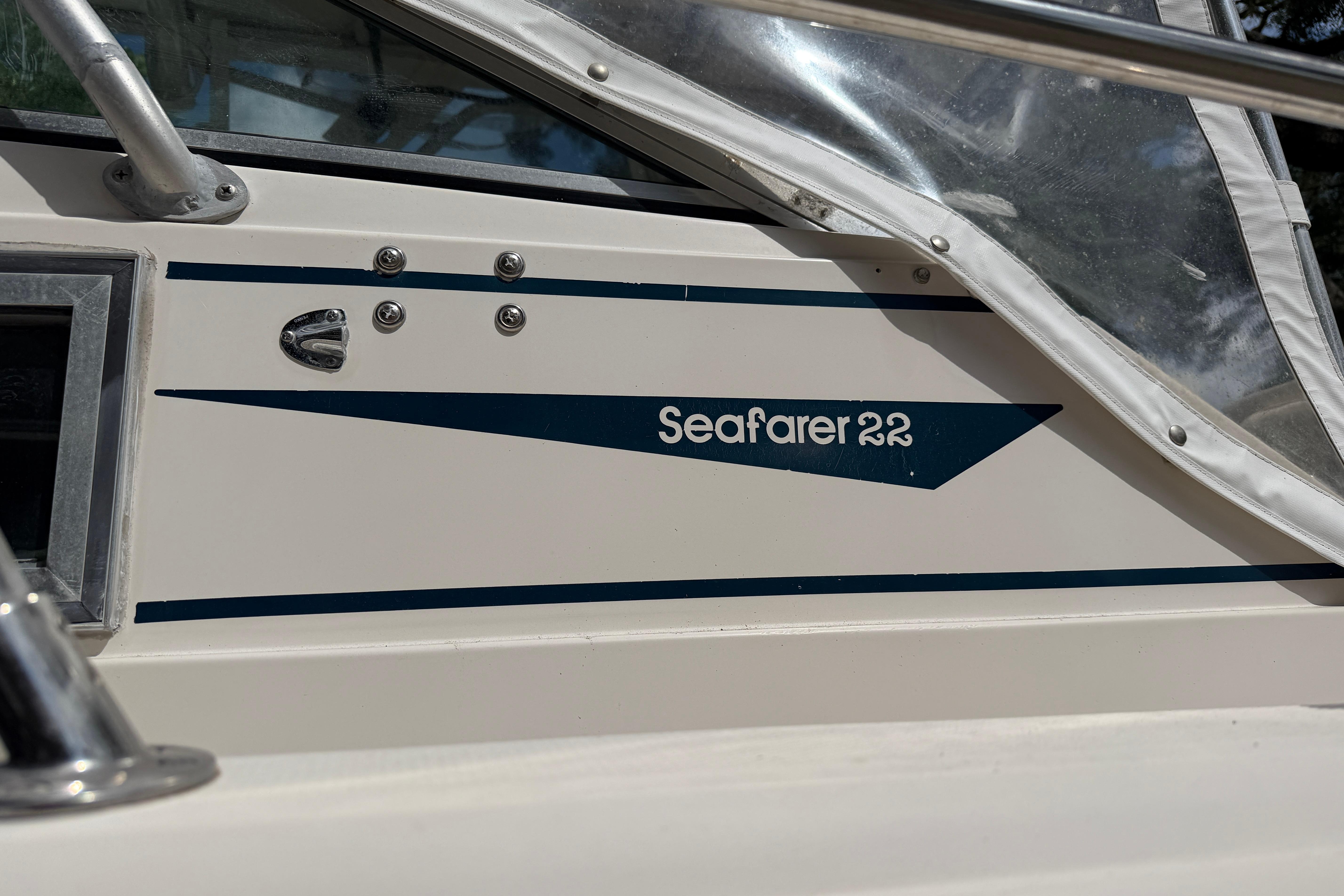 1987 Grady-White Seafarer 226 boat side view with logo and window details.