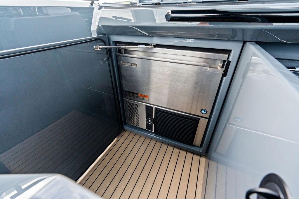 2024 Vanquish Yachts VQ55 interior with stainless steel refrigerator and sleek design.