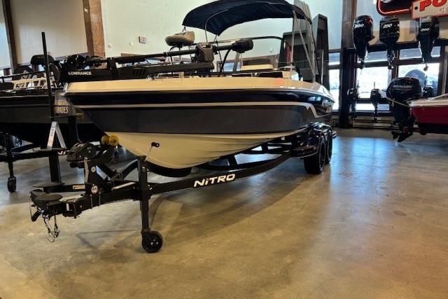 2023 Nitro ZV20 Pro boat on trailer in showroom, featuring sleek design and modern equipment.