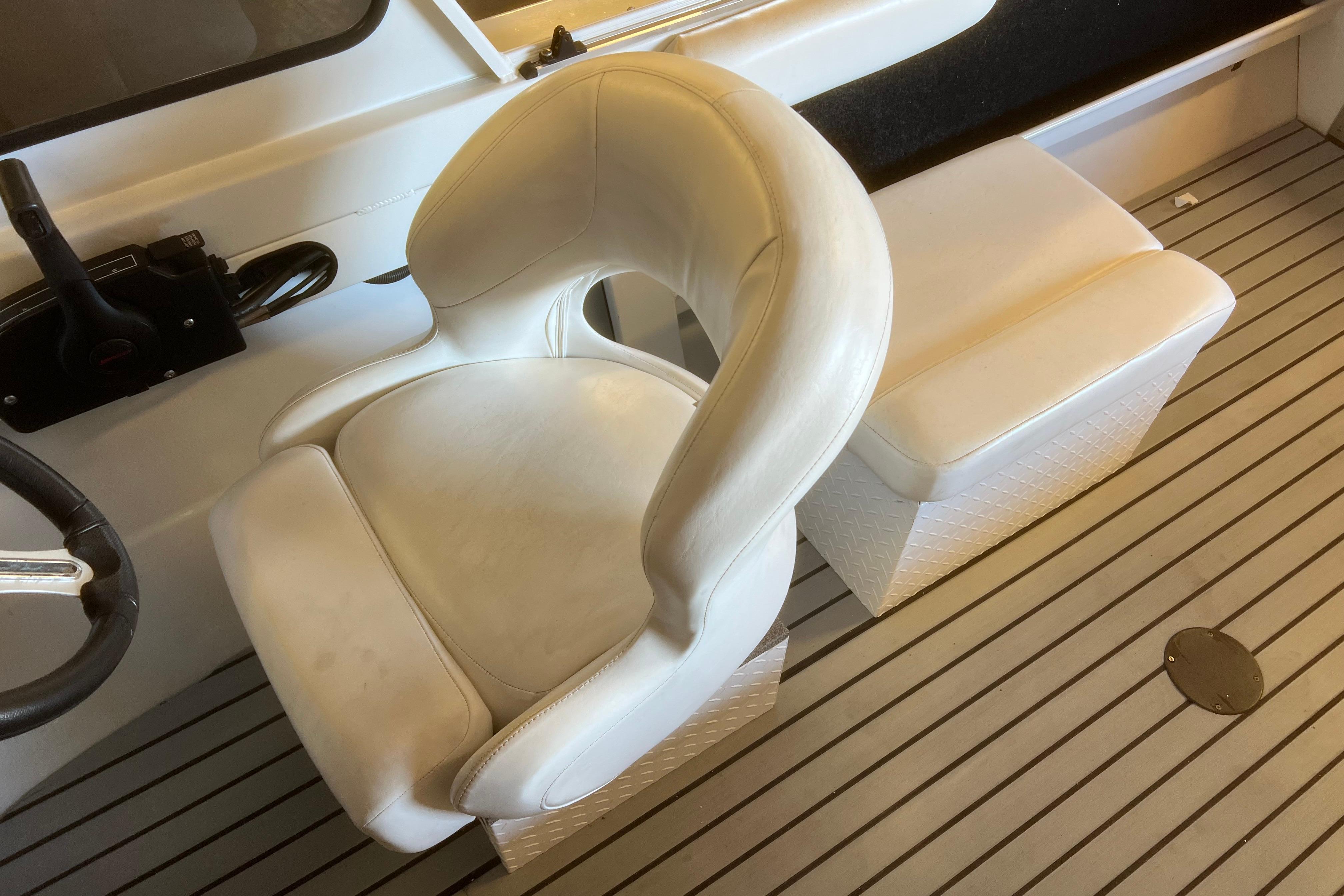 White captain's chair and seat on 2019 KingFisher 1825 Falcon boat interior.