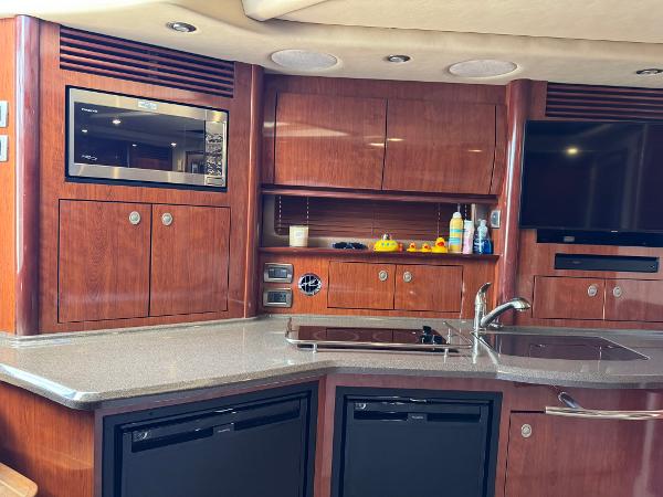 Luxurious 2004 Sea Ray 390 Sundancer yacht interior with modern kitchen amenities.