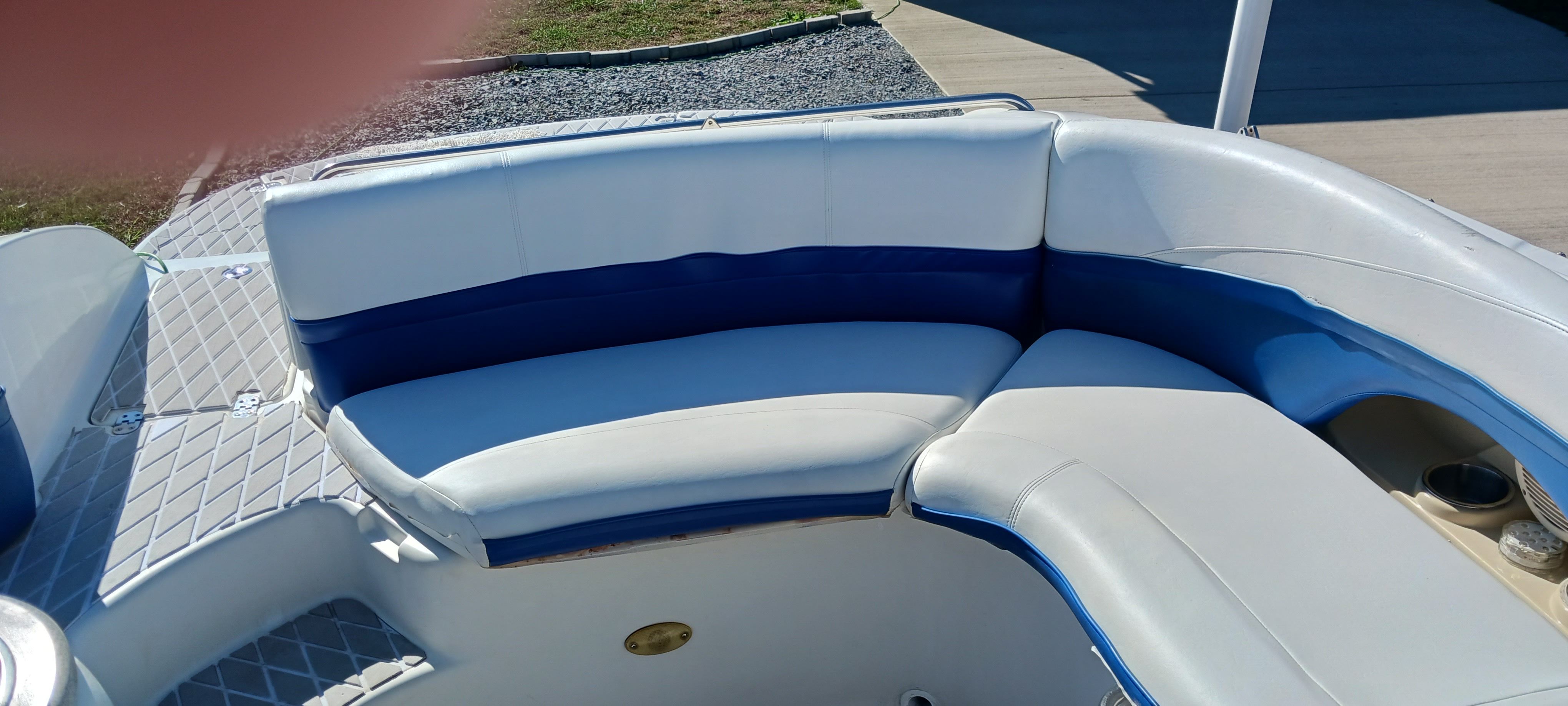 2003 Four Winns 205 Sundowner boat interior with white and blue seating.