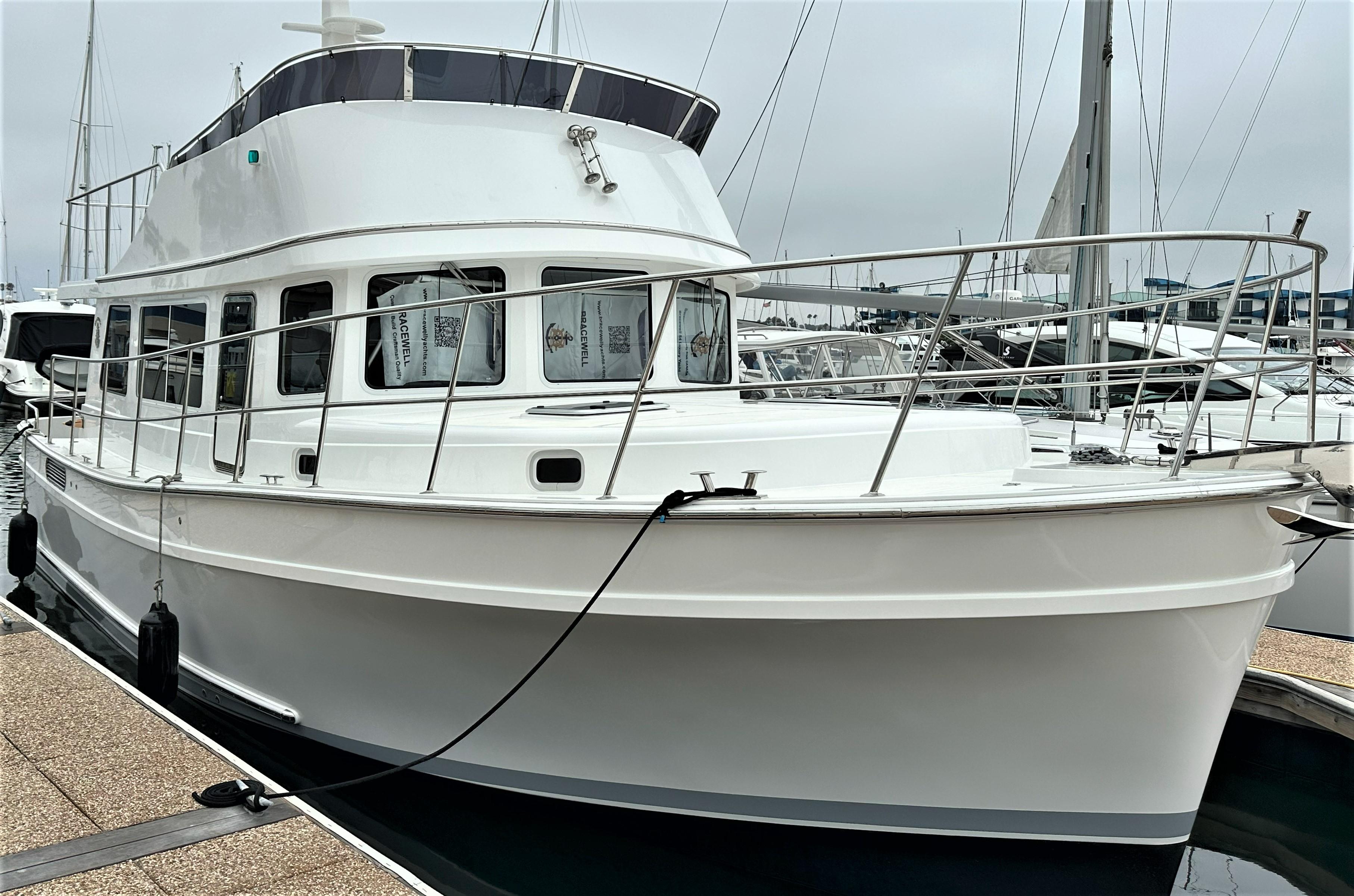 2025 Bracewell 41 yacht docked at marina, featuring sleek white design and spacious deck.
