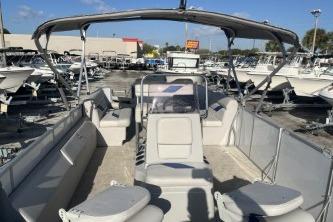 2023 Suntracker G3 Select 322 CC pontoon boat with spacious seating and canopy in a marina.