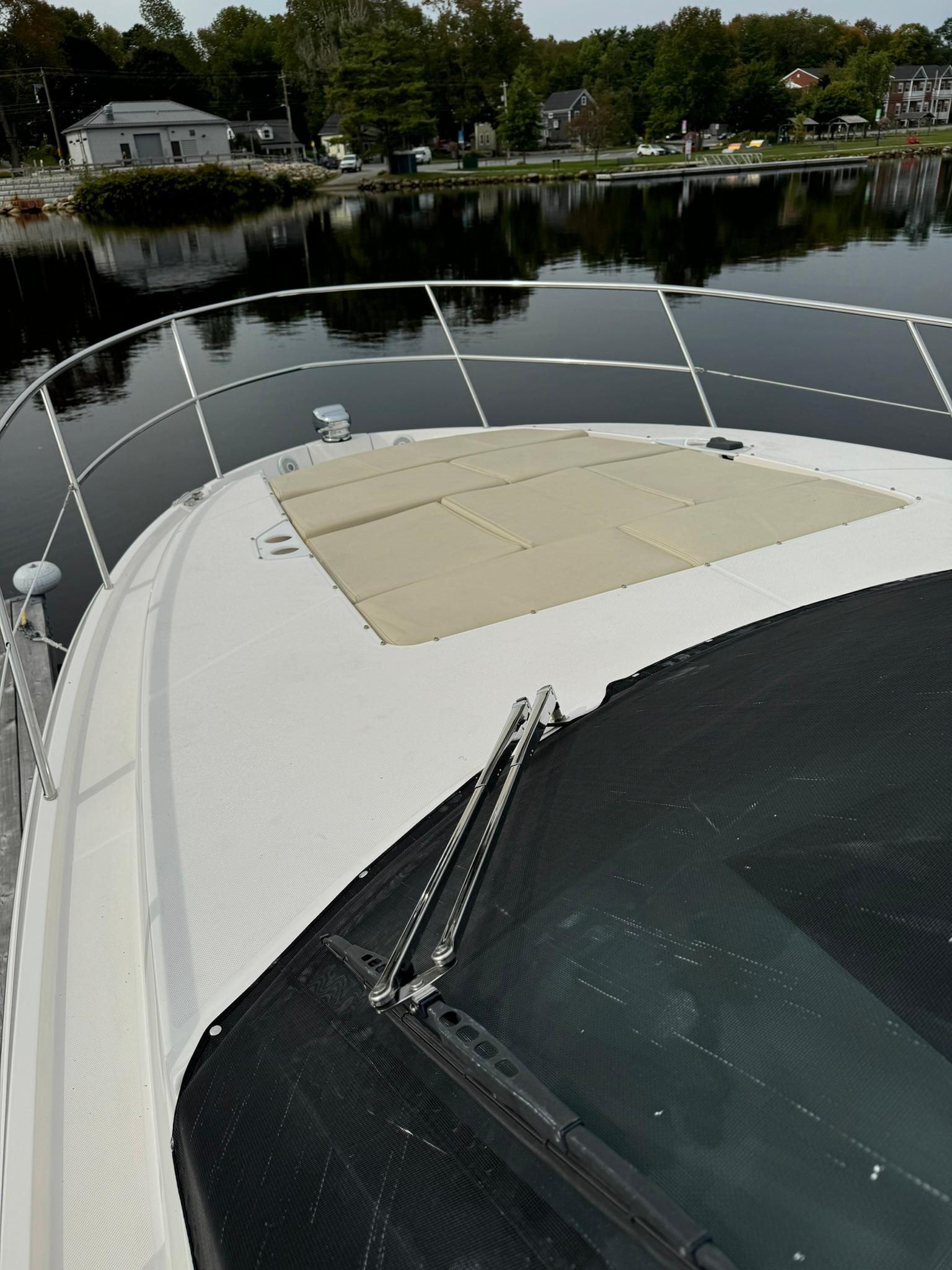 2020 Regal 38 Grande Coupe yacht on calm water, showcasing sleek deck design.