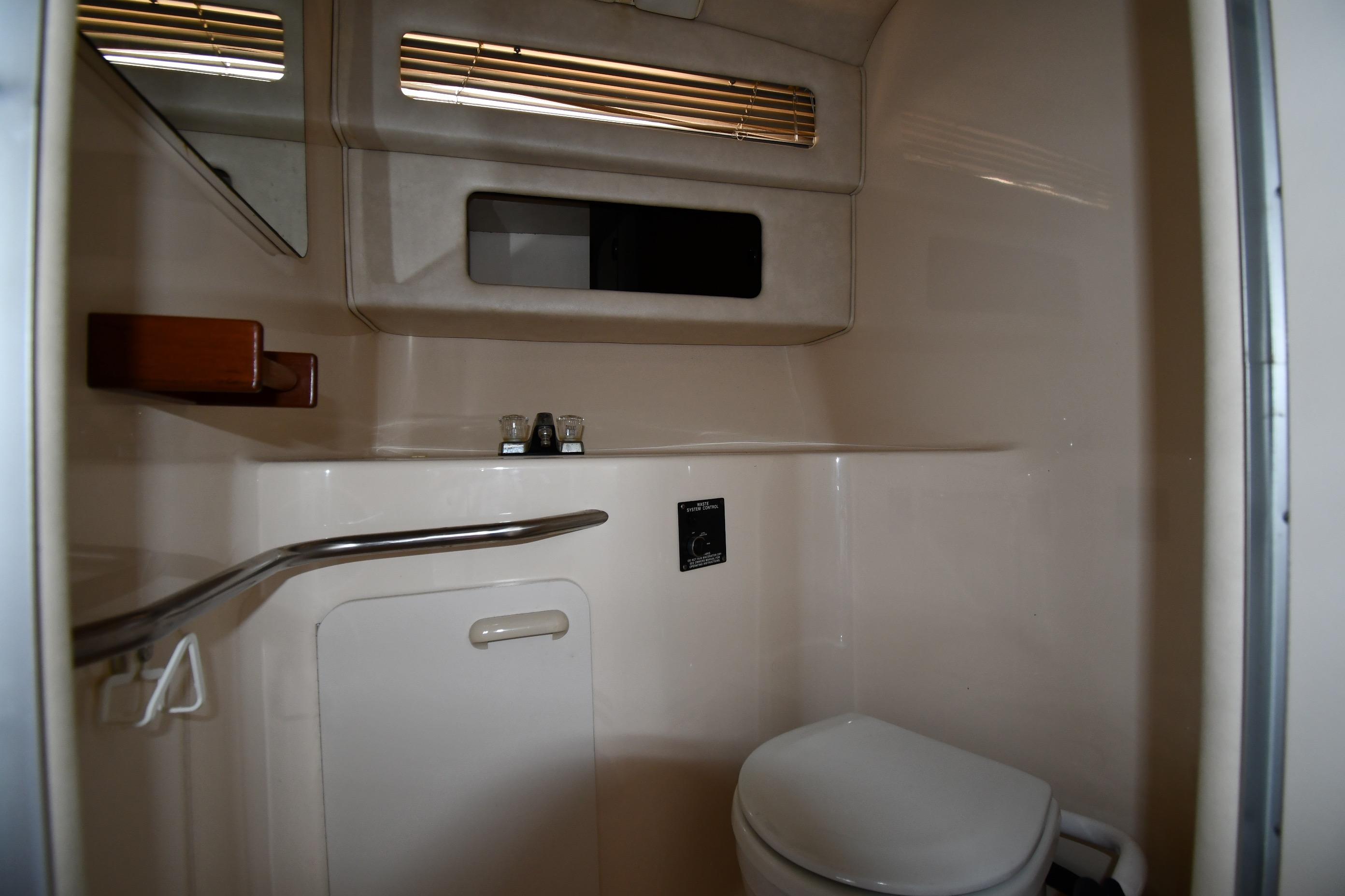 1993 Sea Ray 300 Sundancer bathroom interior with toilet and sink.