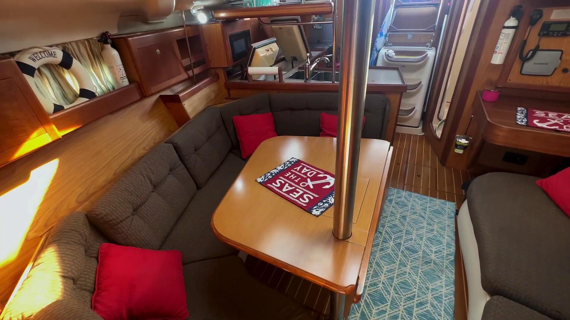 Cozy interior of 2001 Hunter 380 sailboat with dining area and nautical decor.