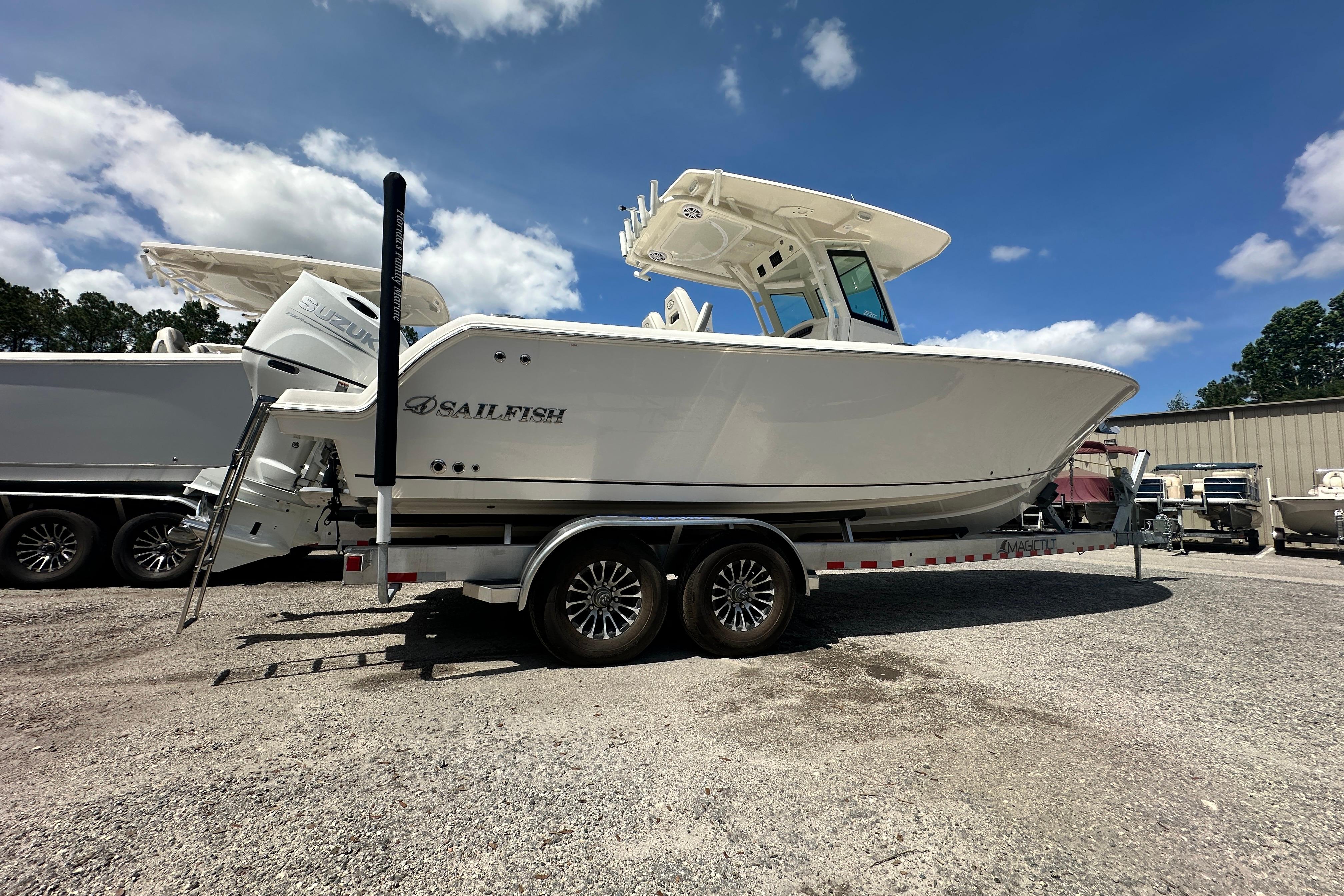 2026 Sailfish 272 CC boat on trailer under clear blue sky.