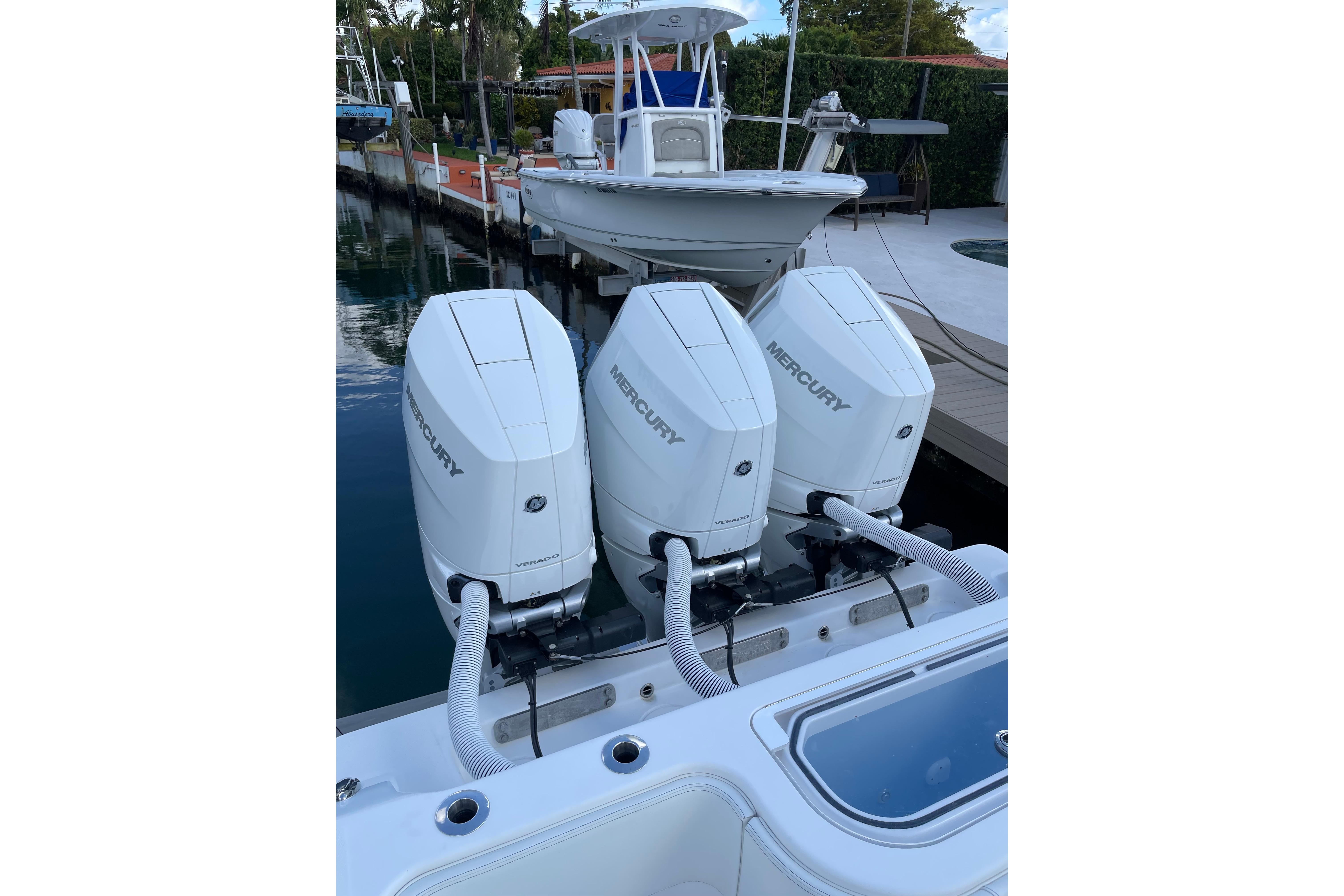 2024 Invincible 36 Open Fisherman with triple Mercury outboard engines docked by the water.