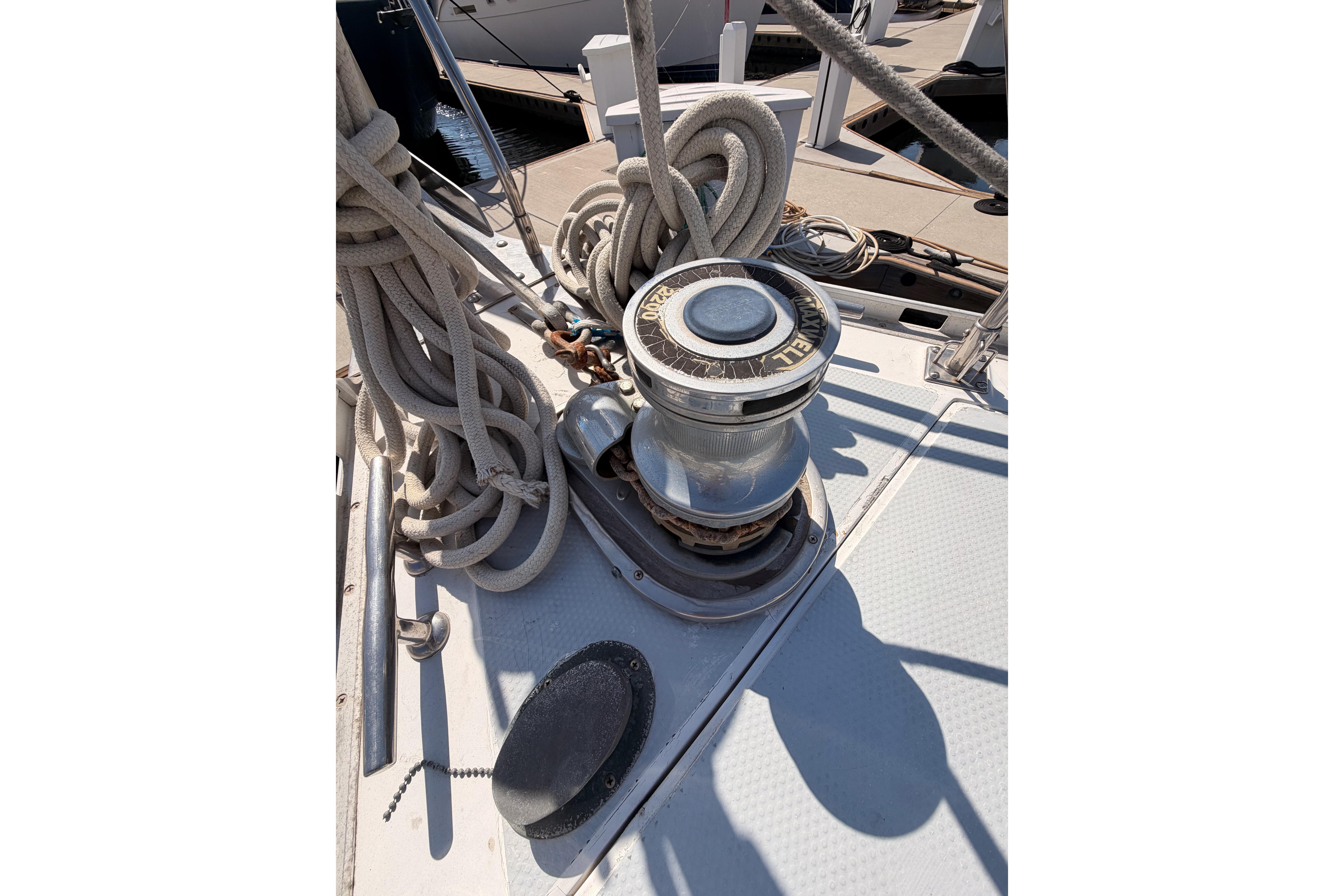 Deck of 1991 Hylas 51 sailboat with winch and coiled ropes.