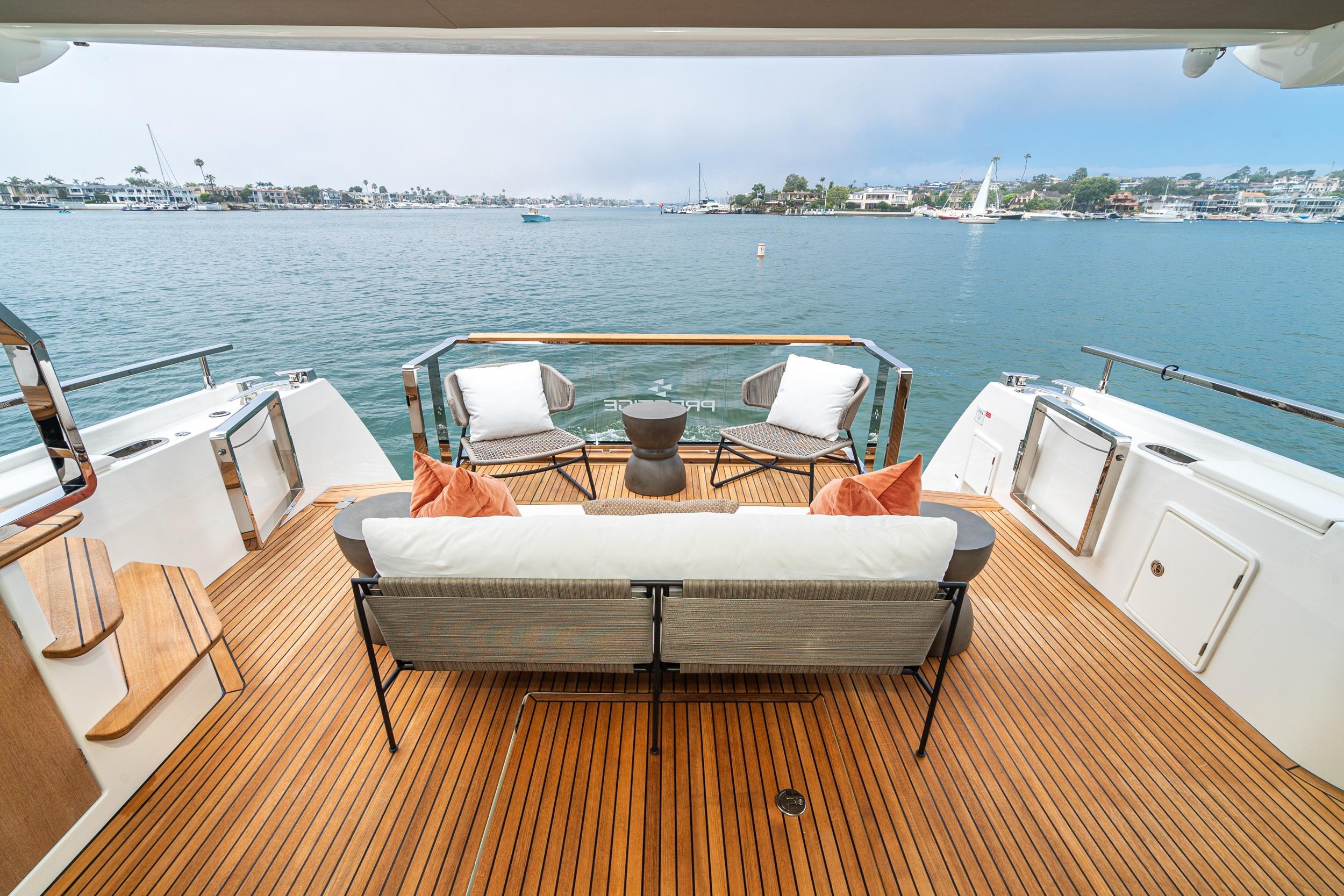 Luxurious 2024 Prestige X60 yacht deck with elegant seating and scenic ocean view.