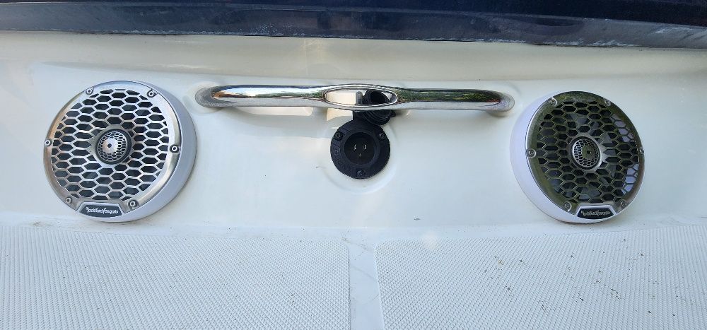 Two speakers and a handle on a boat.