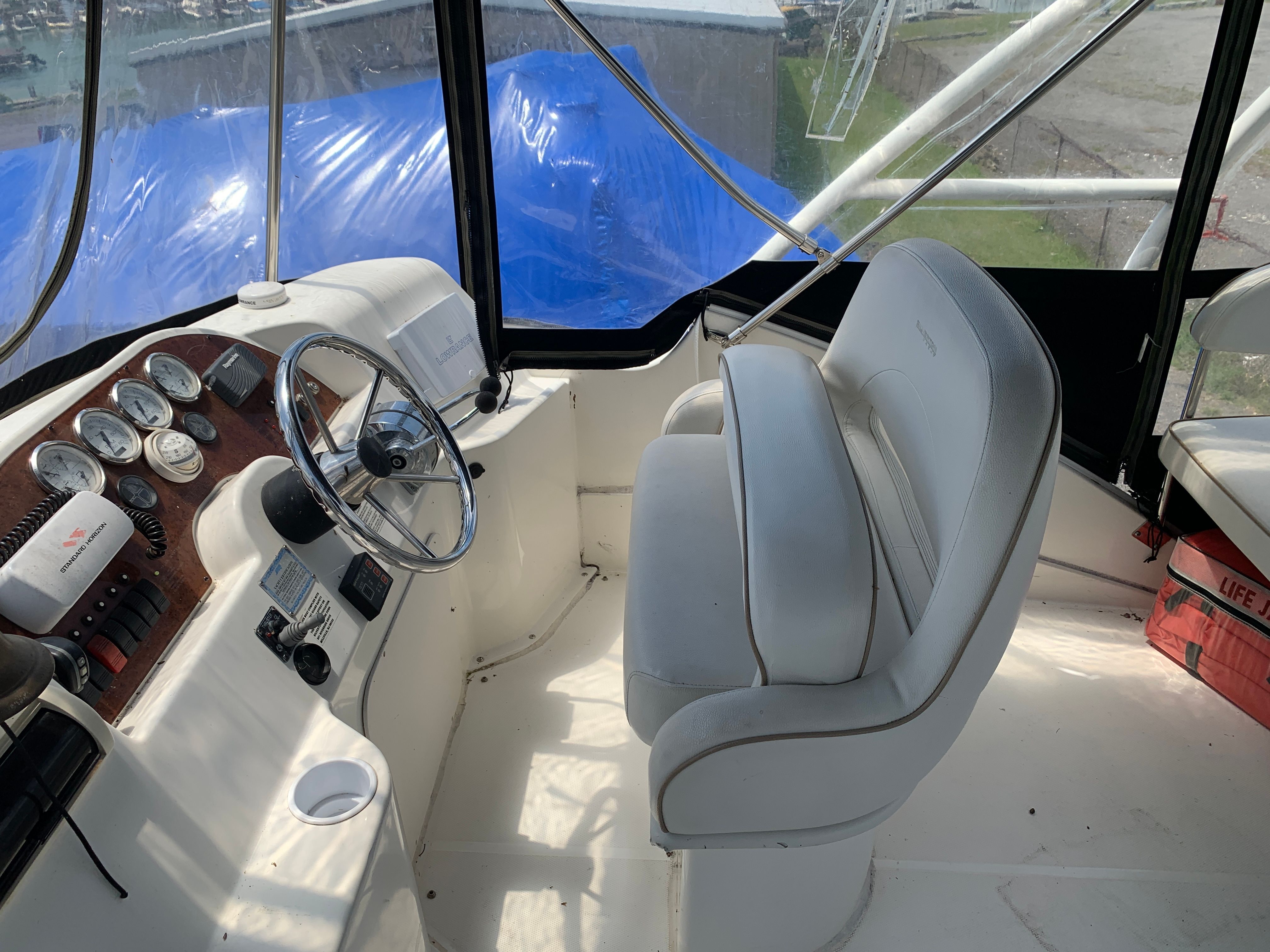 Interior of a Silverton 33 Convertible boat with helm and seating.