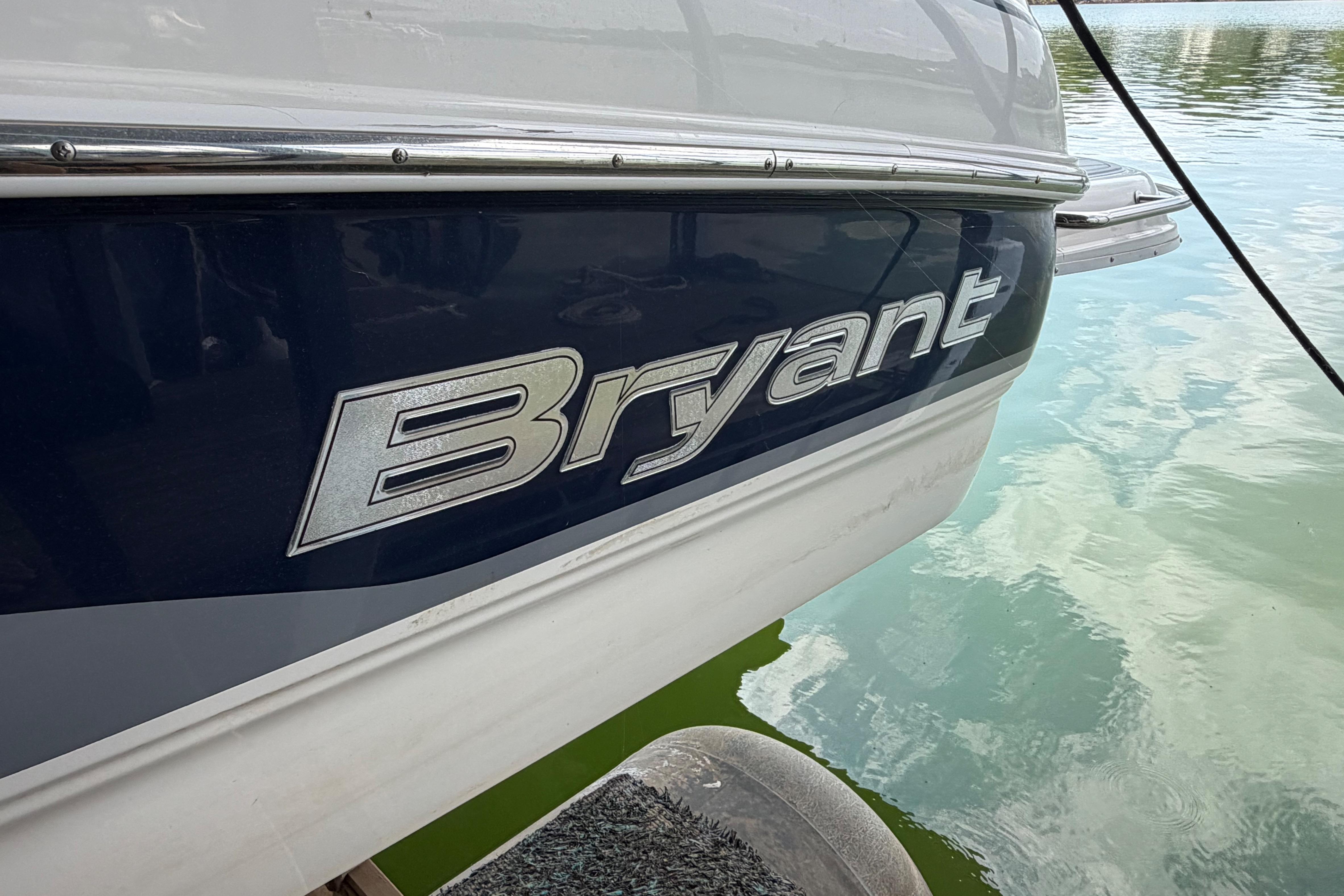 2010 Bryant 255 boat side view on water, showcasing brand logo.