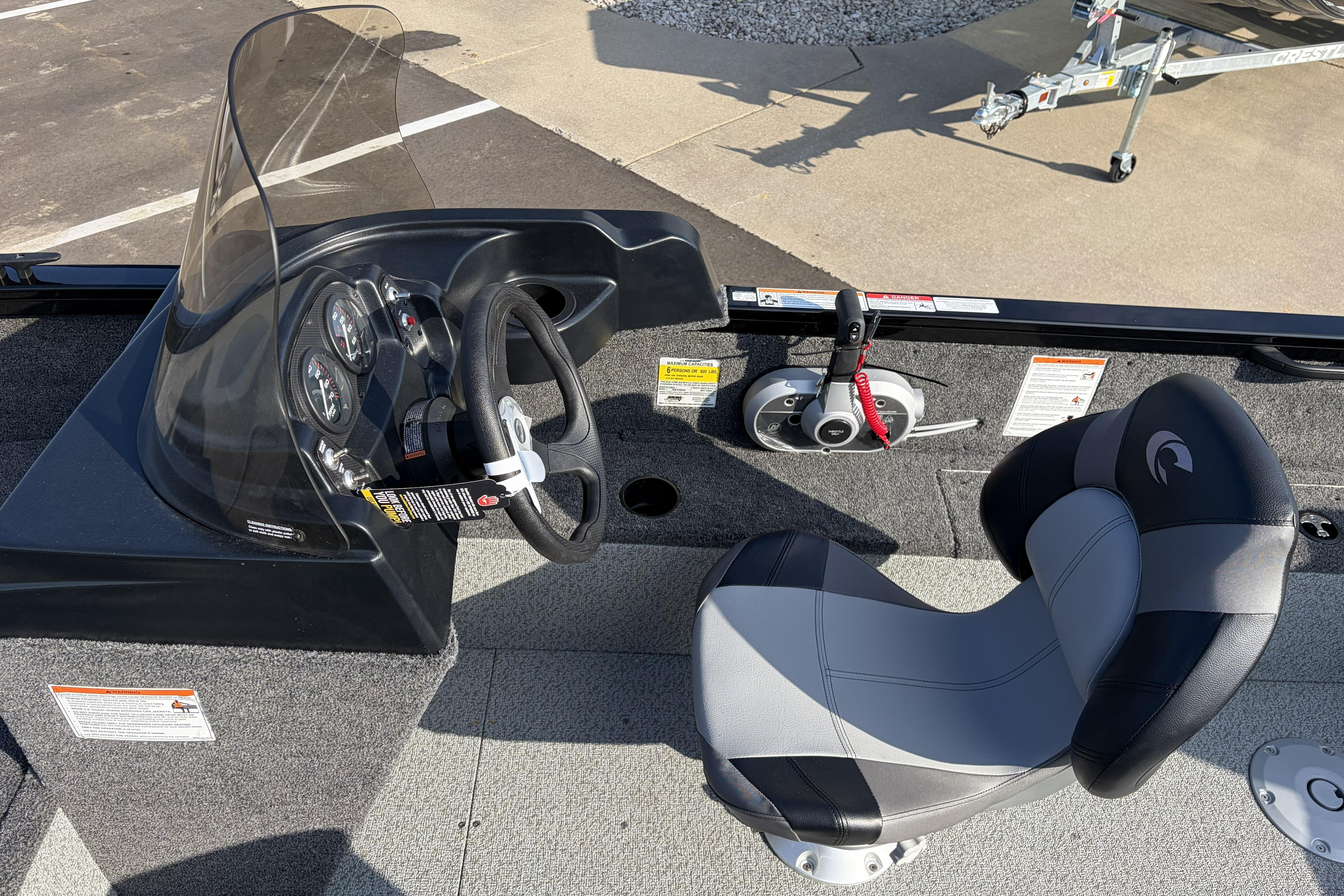 2026 Crestliner 1850 Kodiak SC boat cockpit with steering wheel and seat.