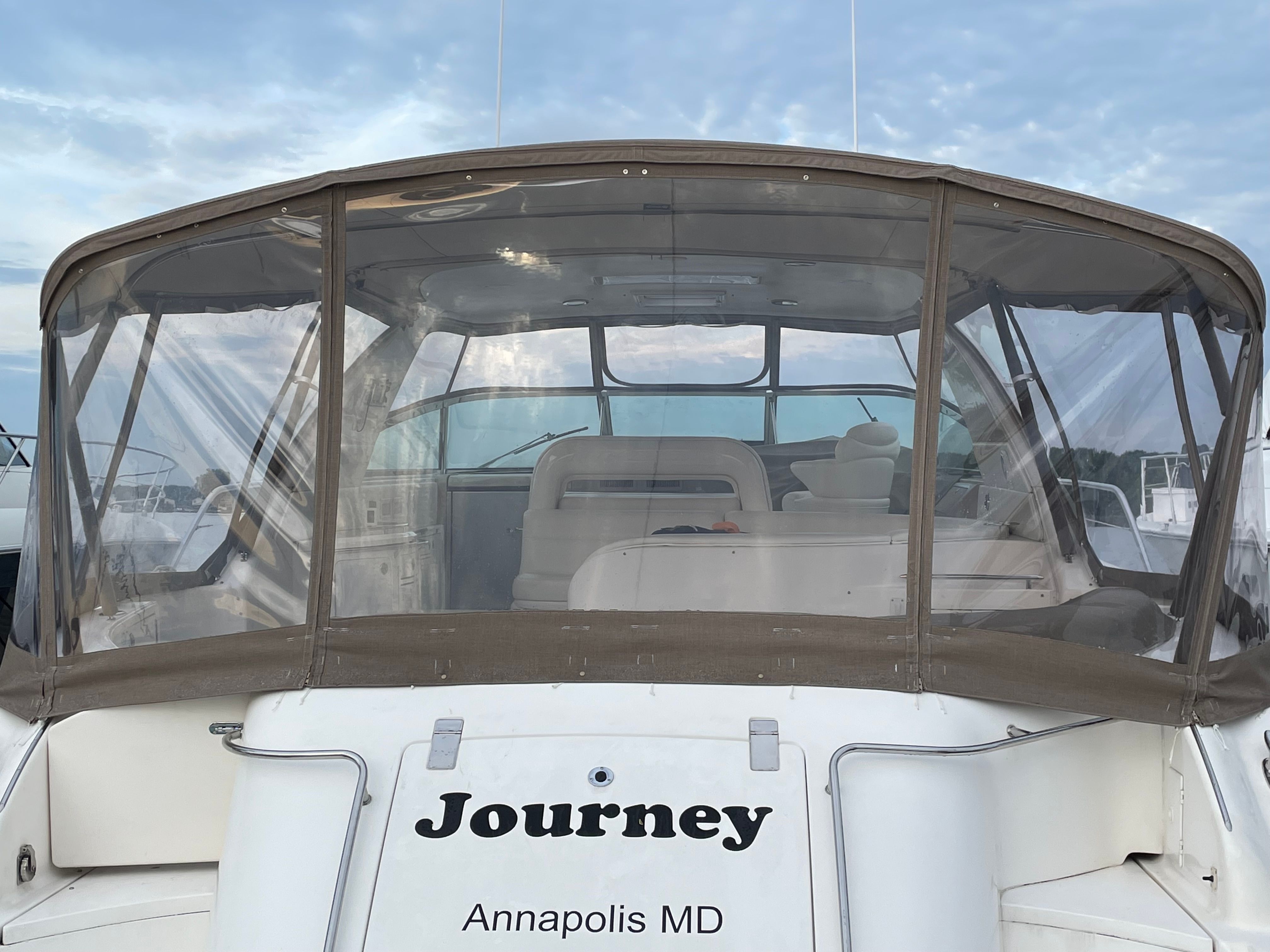 The image shows the stern of a Sea Ray S600 Sunsport boat named "Journey." It has a clear cover and is located in Annapolis, MD.