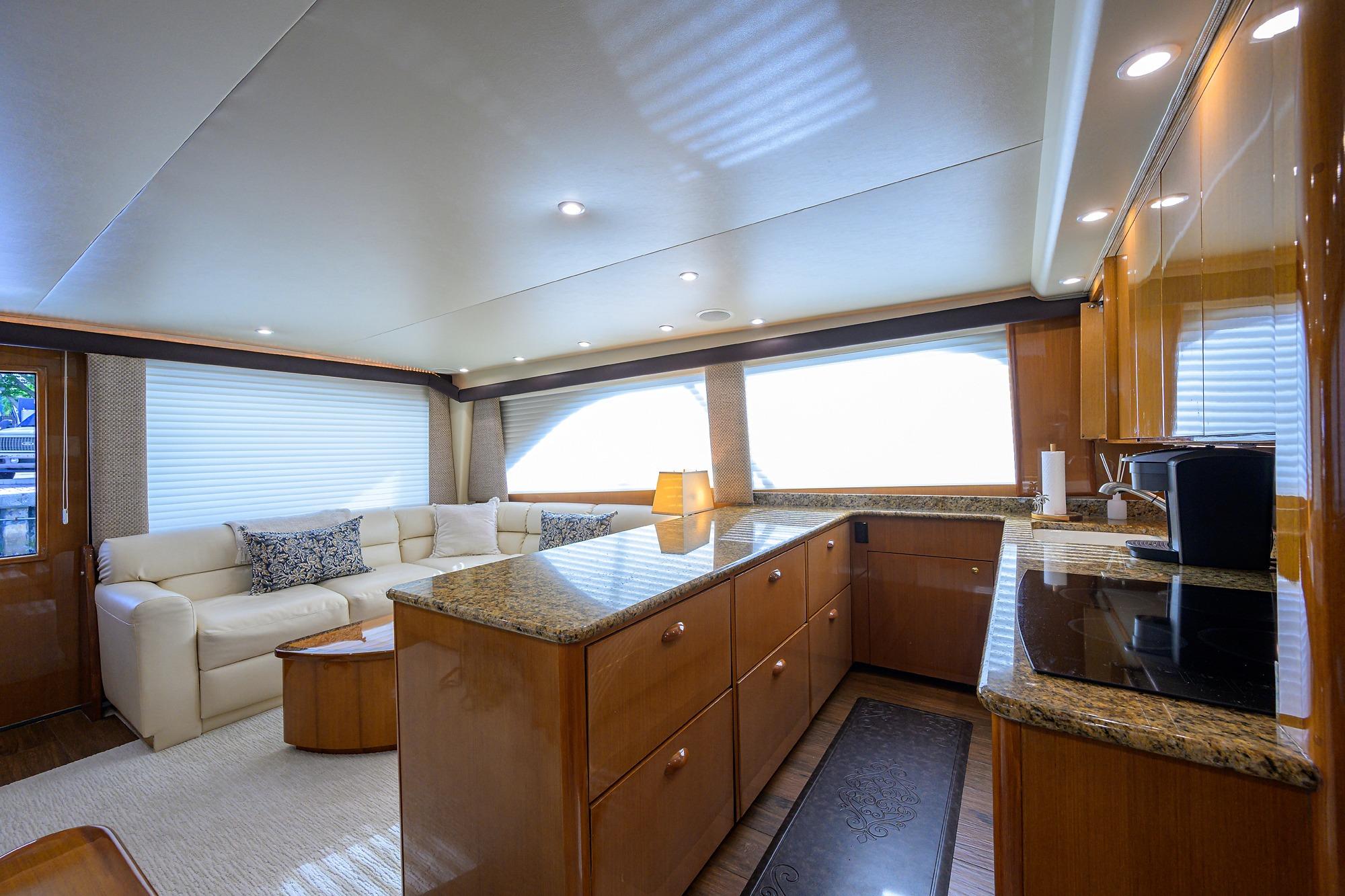 Luxurious interior of a 2004 Viking 56 Convertible yacht with modern kitchen and seating area.