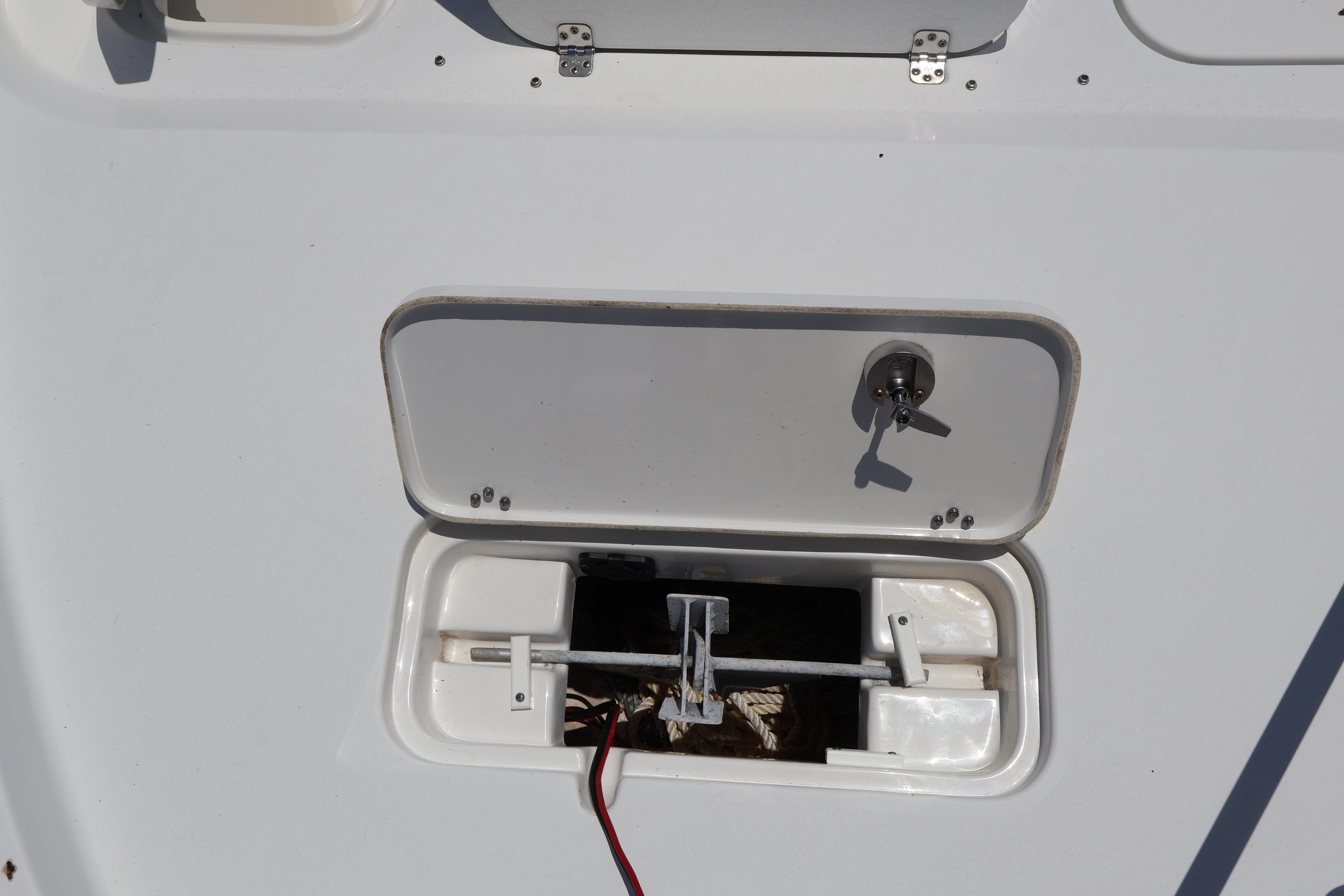 2022 Sea Hunt BX 25 FS boat compartment with open hatch and visible wiring.
