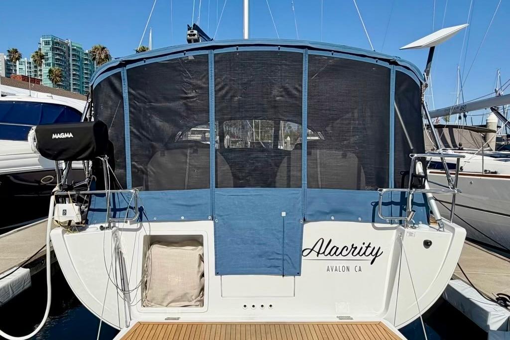 Hanse 455 sailboat, 2016 model, docked with blue canvas cover, named "Alacrity" in Avalon, CA.
