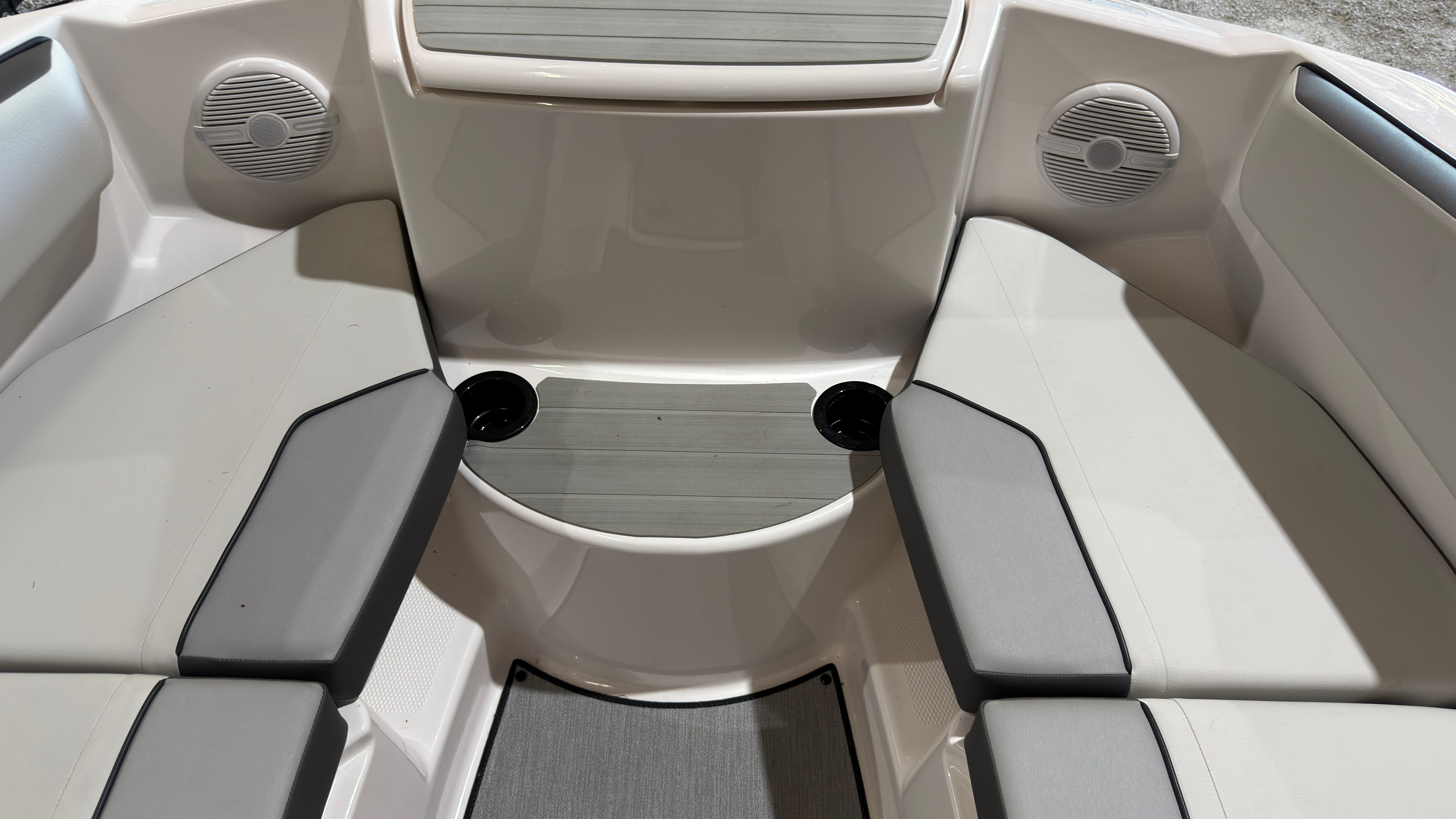 Interior of Yamaha AR220 boat, 2024 model, featuring seating and speakers.