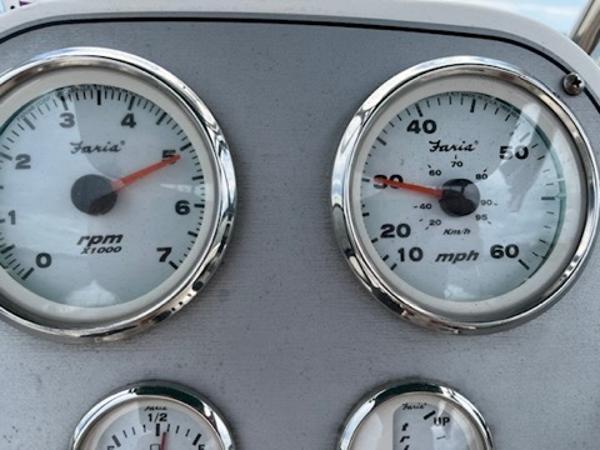 Dashboard gauges of a 2003 Wellcraft 180 Fisherman boat, showing RPM and speed in mph.