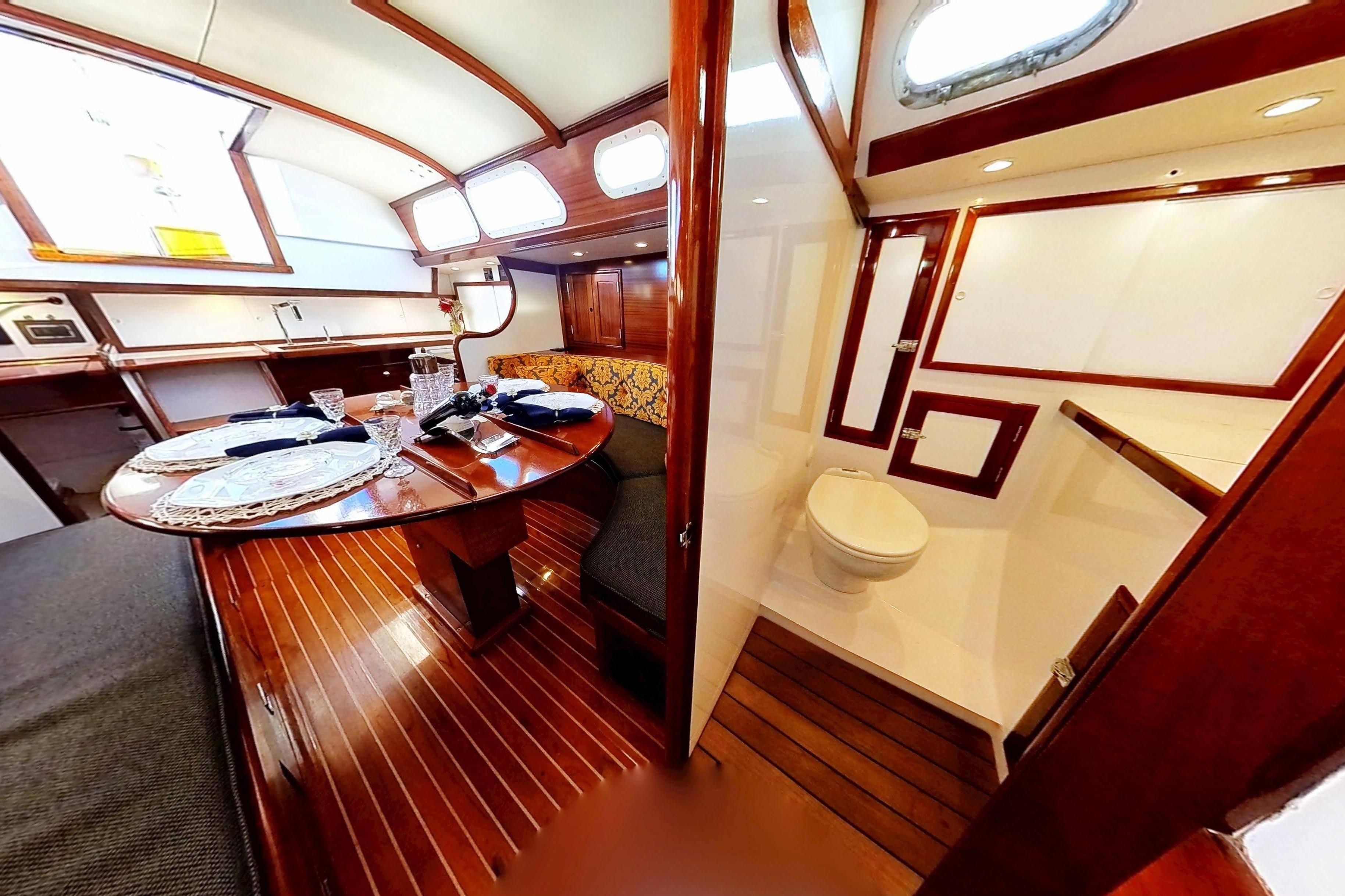 Interior of 1970 Hinckley Bermuda 40 yacht with dining area and bathroom.