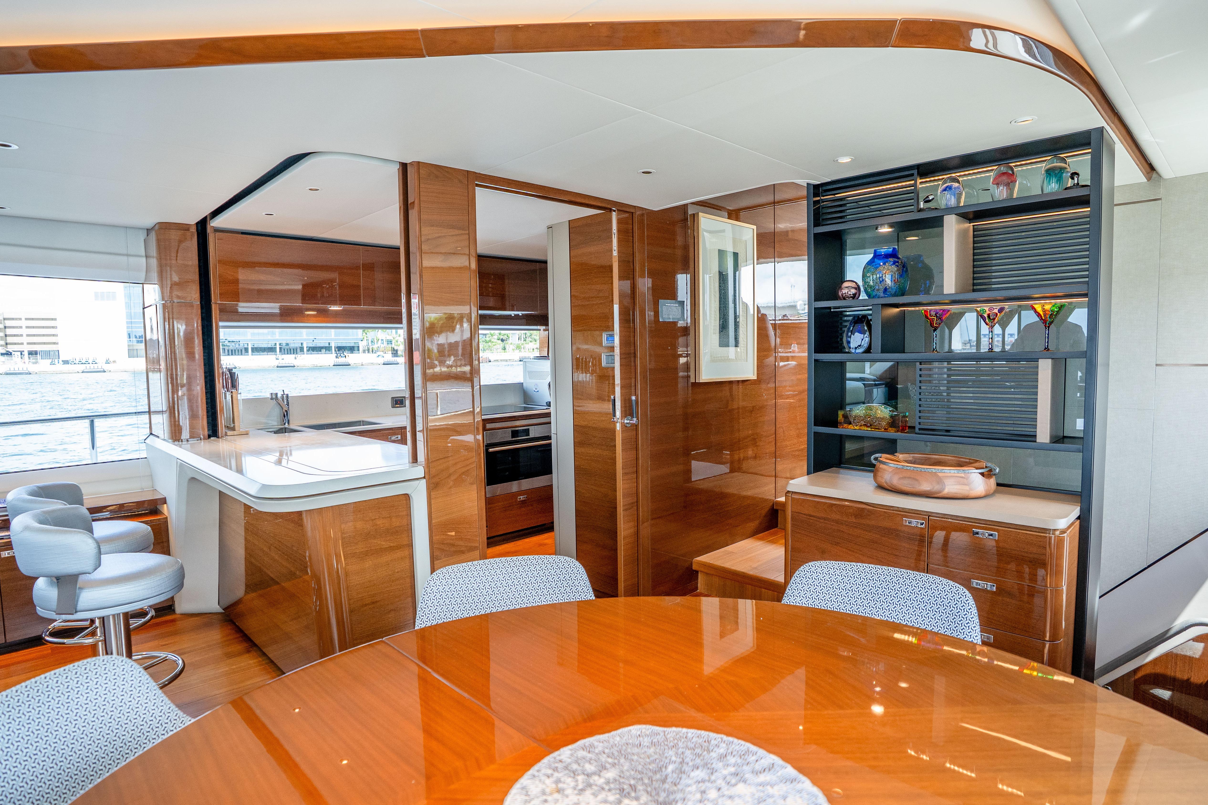 Luxurious interior of 2020 Princess Y85 yacht with modern kitchen and elegant dining area.