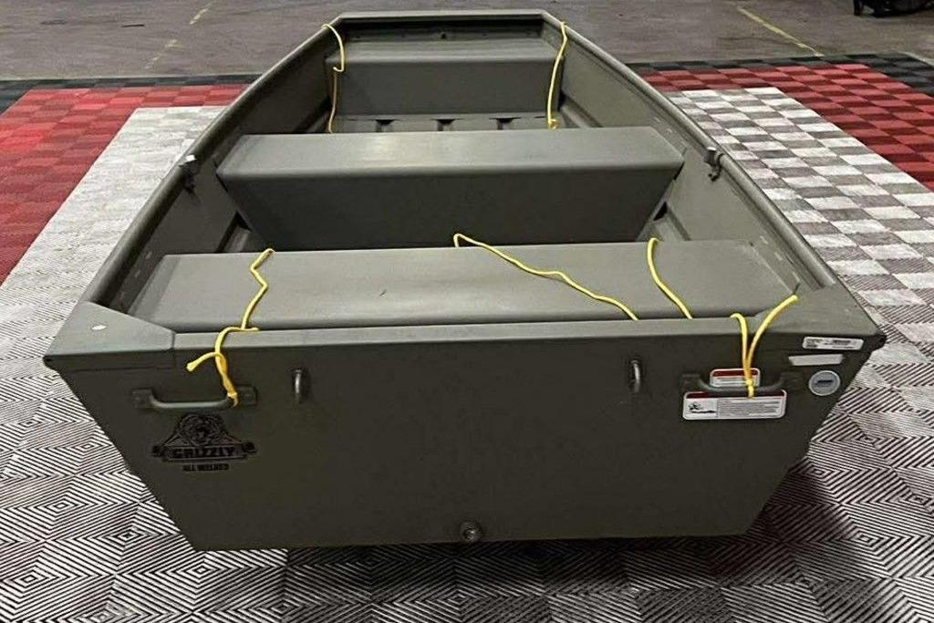 2026 Tracker Grizzly 12 Jon boat on checkered floor, featuring yellow ropes.