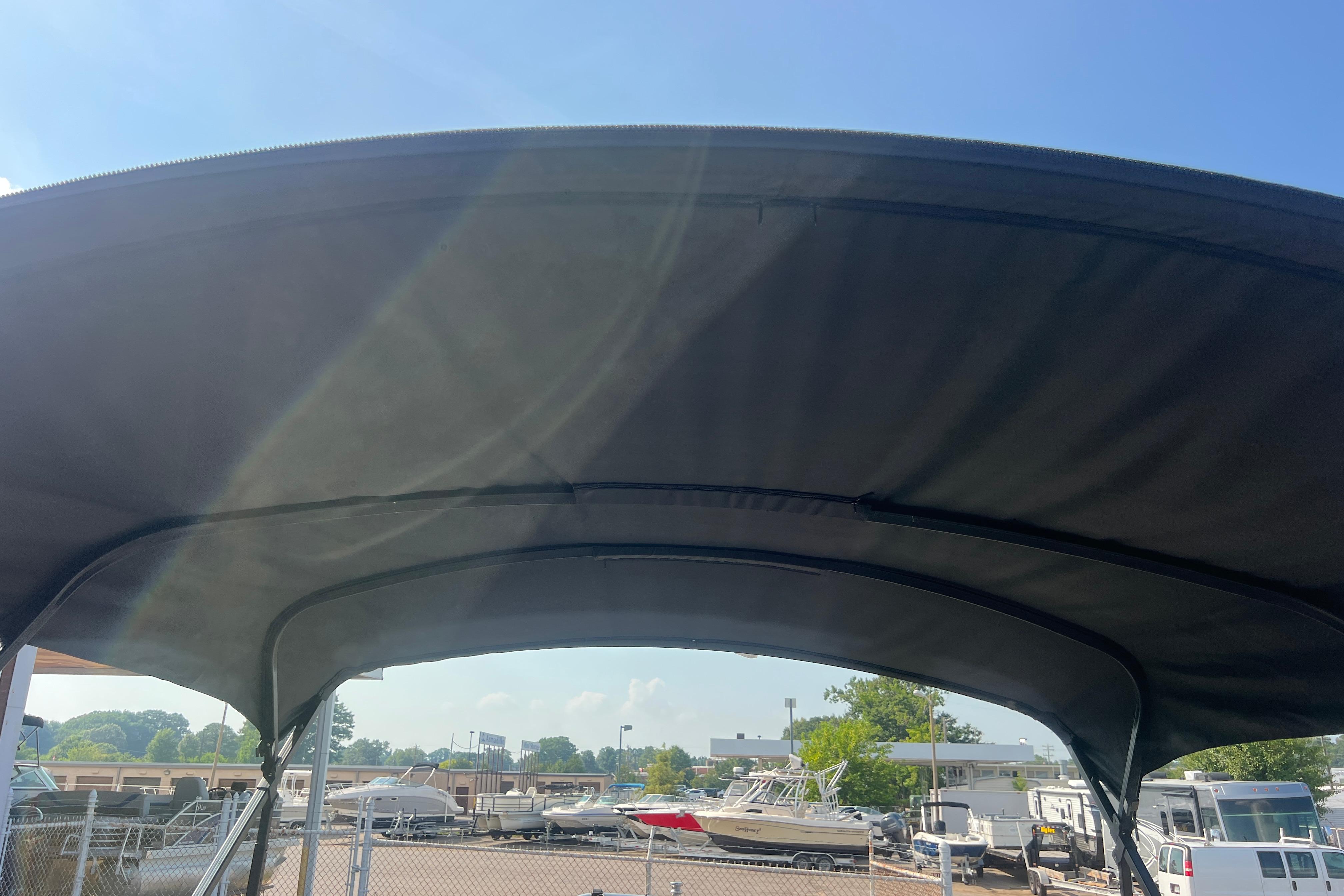Bimini top of 2022 Viaggio Lago V-U 22 boat under clear blue sky.