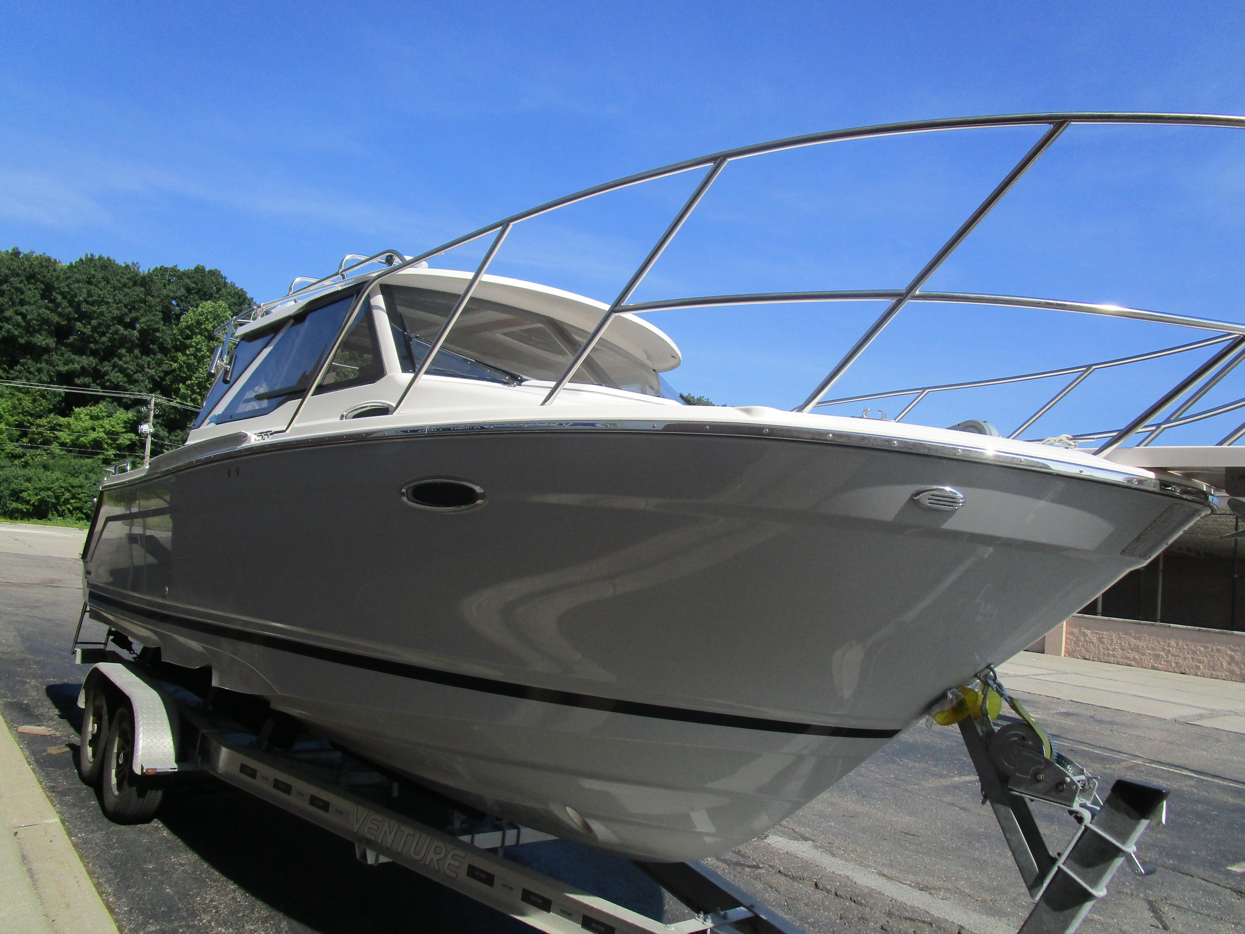 2025 Cutwater C-248 Coupe boat on trailer under clear blue sky.