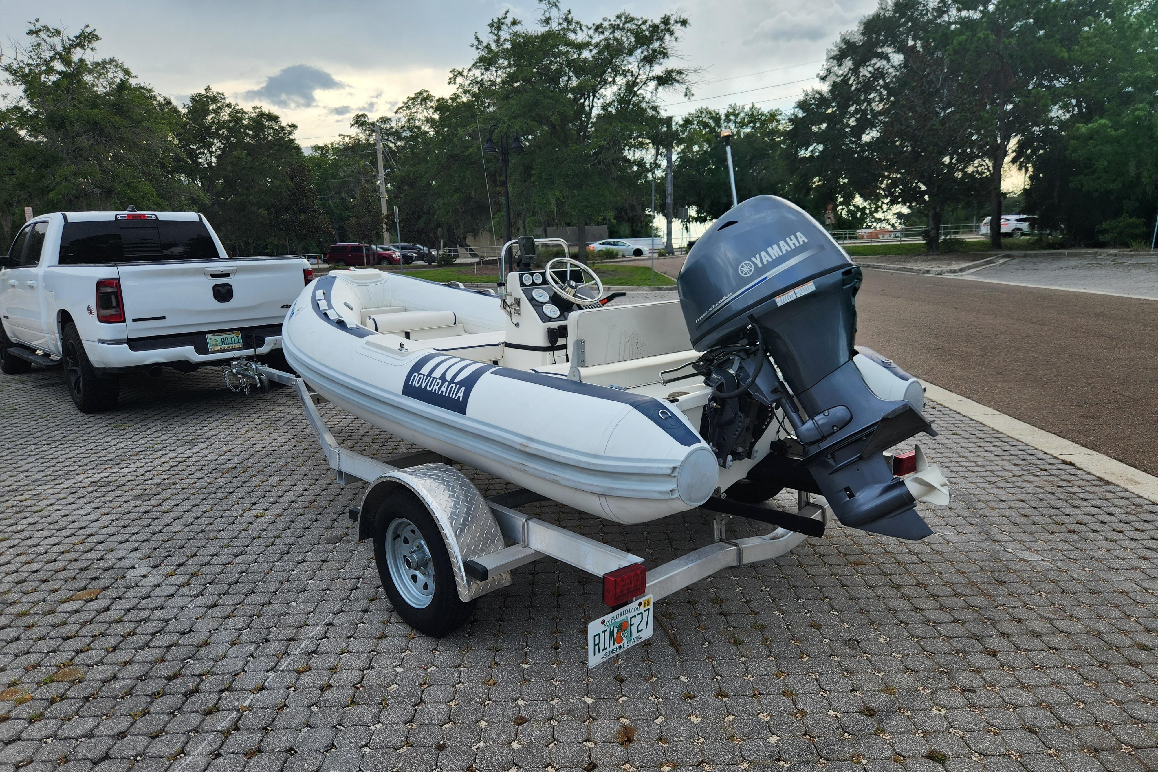 2019 Novurania DL 400 boat on trailer, equipped with Yamaha outboard motor, parked outdoors.