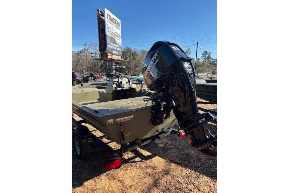 2026 Tracker Grizzly 1648 SC boat with Mercury outboard motor, parked outdoors.