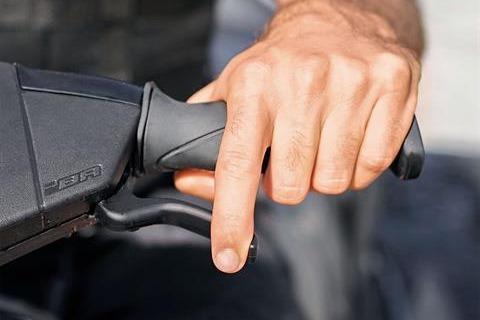 Close-up of a hand gripping the throttle of a 2025 Sea-Doo GTI SE 130 watercraft.