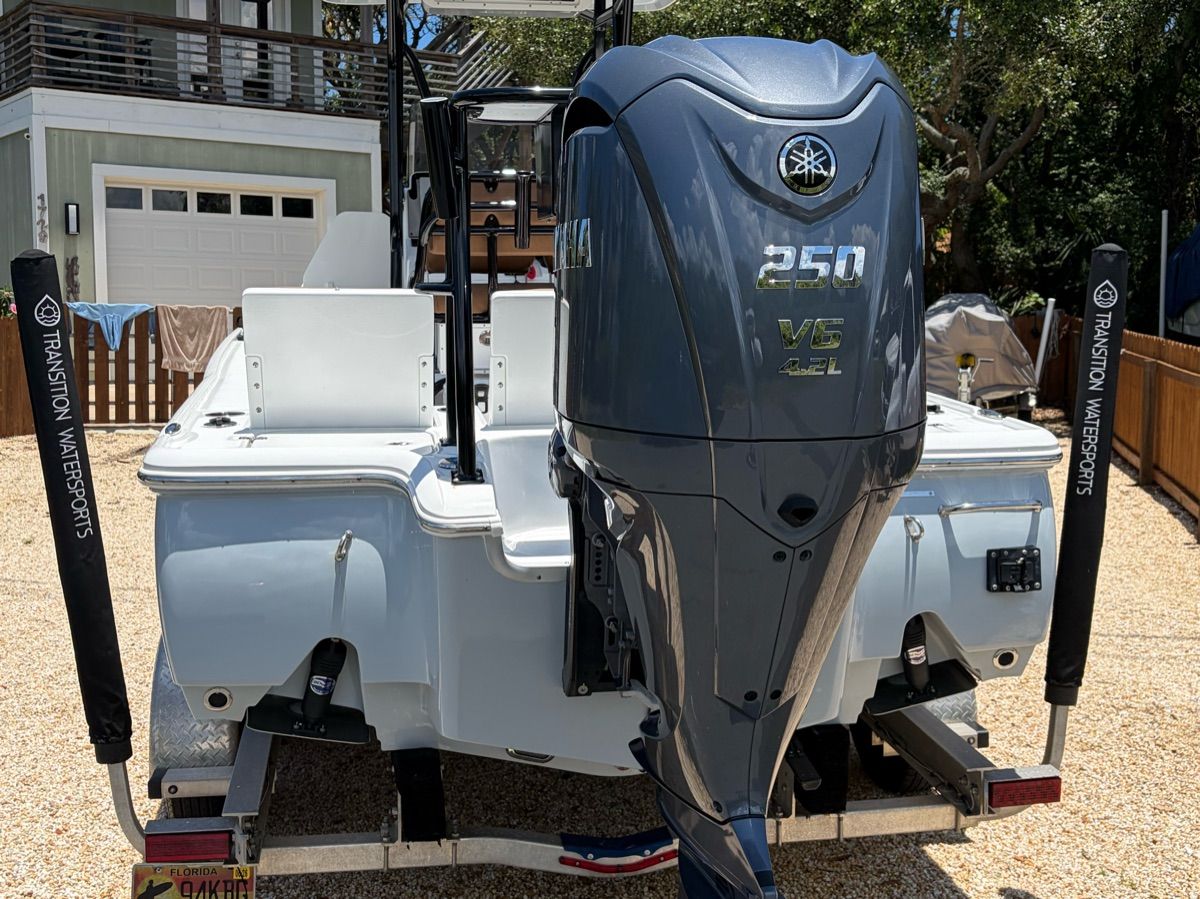 A Sea Hunt BX 22 BR boat with a Yamaha 250 V6 outboard motor on a trailer.