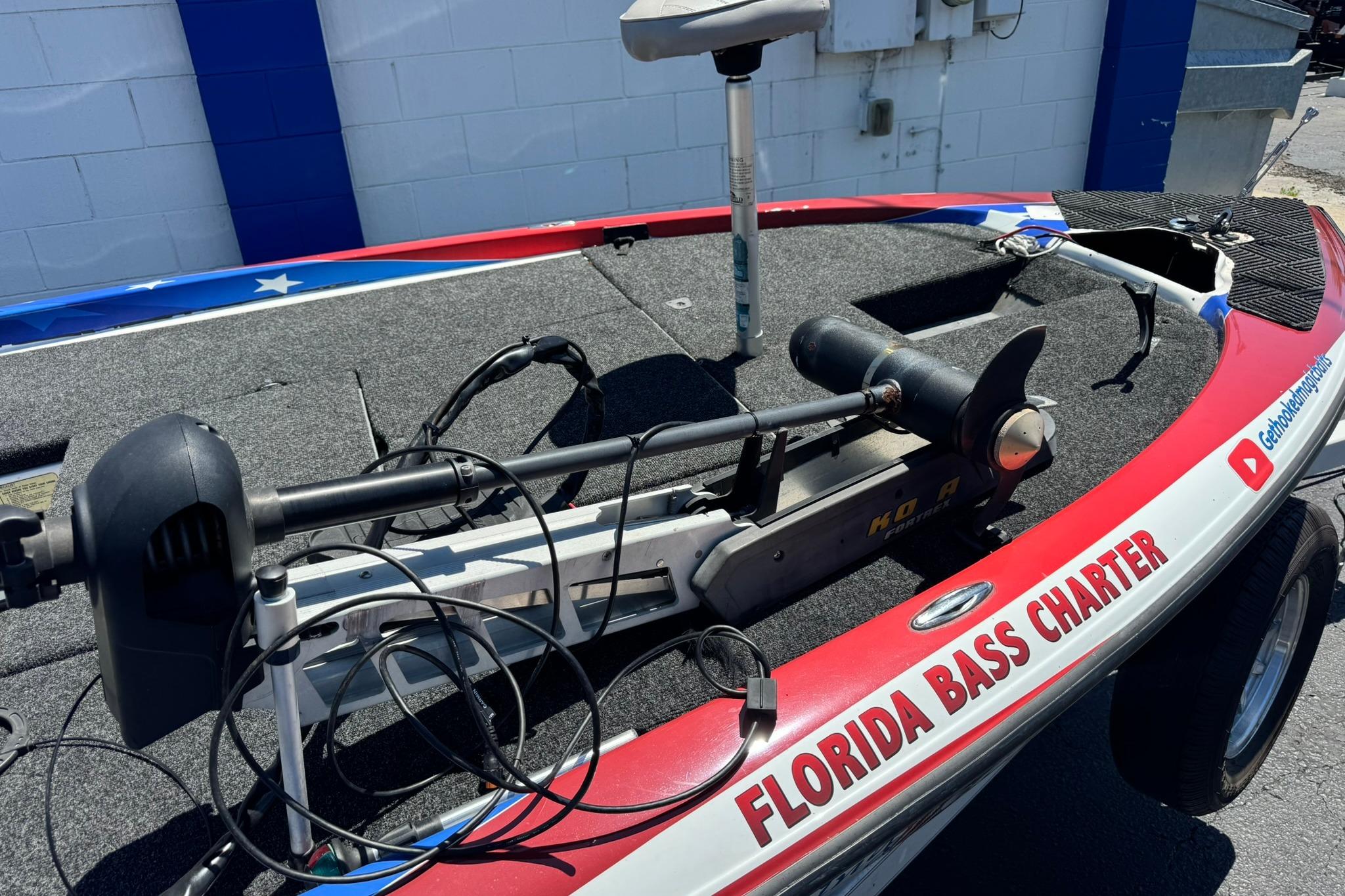 2005 Skeeter ZX225 bass boat with trolling motor, labeled "Florida Bass Charter."