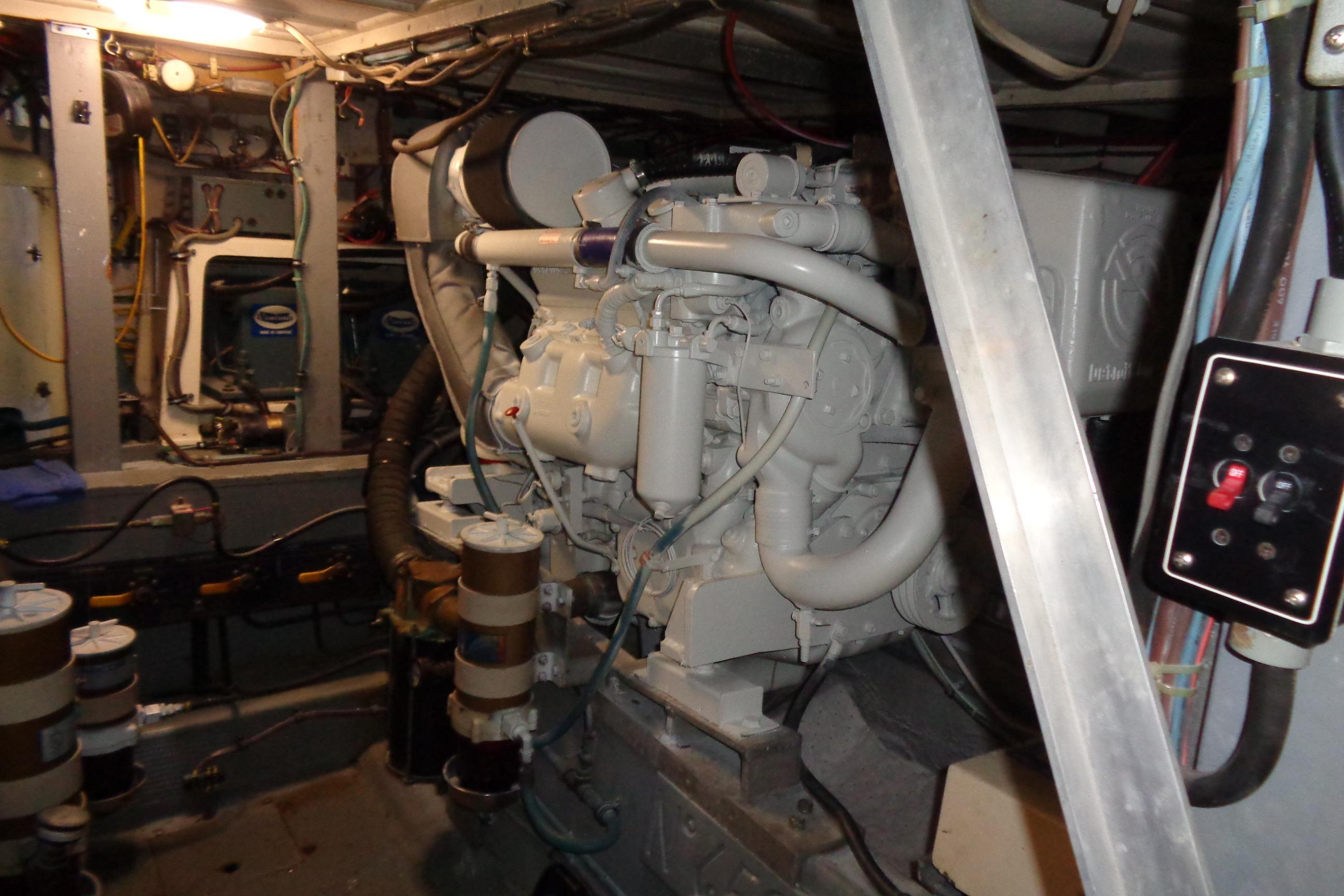 Engine room of 1981 Hatteras 48 Cockpit Motor Yacht, showcasing mechanical components.