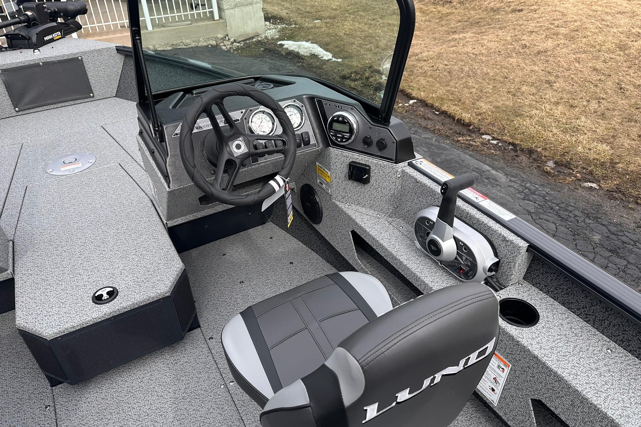 2026 Lund 1775 Adventure Sport boat interior with steering wheel and controls.