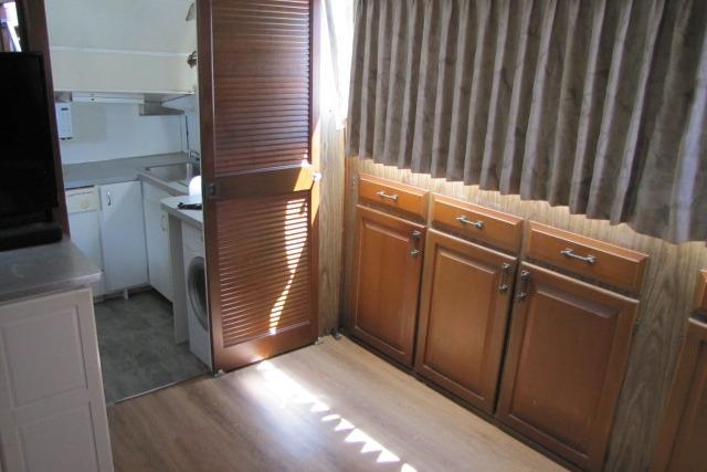 Interior of 1973 Chris-Craft 55 Commander with wooden cabinets and laundry area.