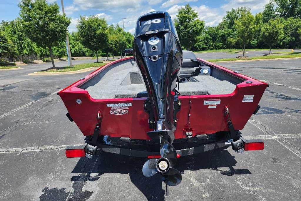2025 Tracker Super Guide V-16 T boat with outboard motor in parking lot.