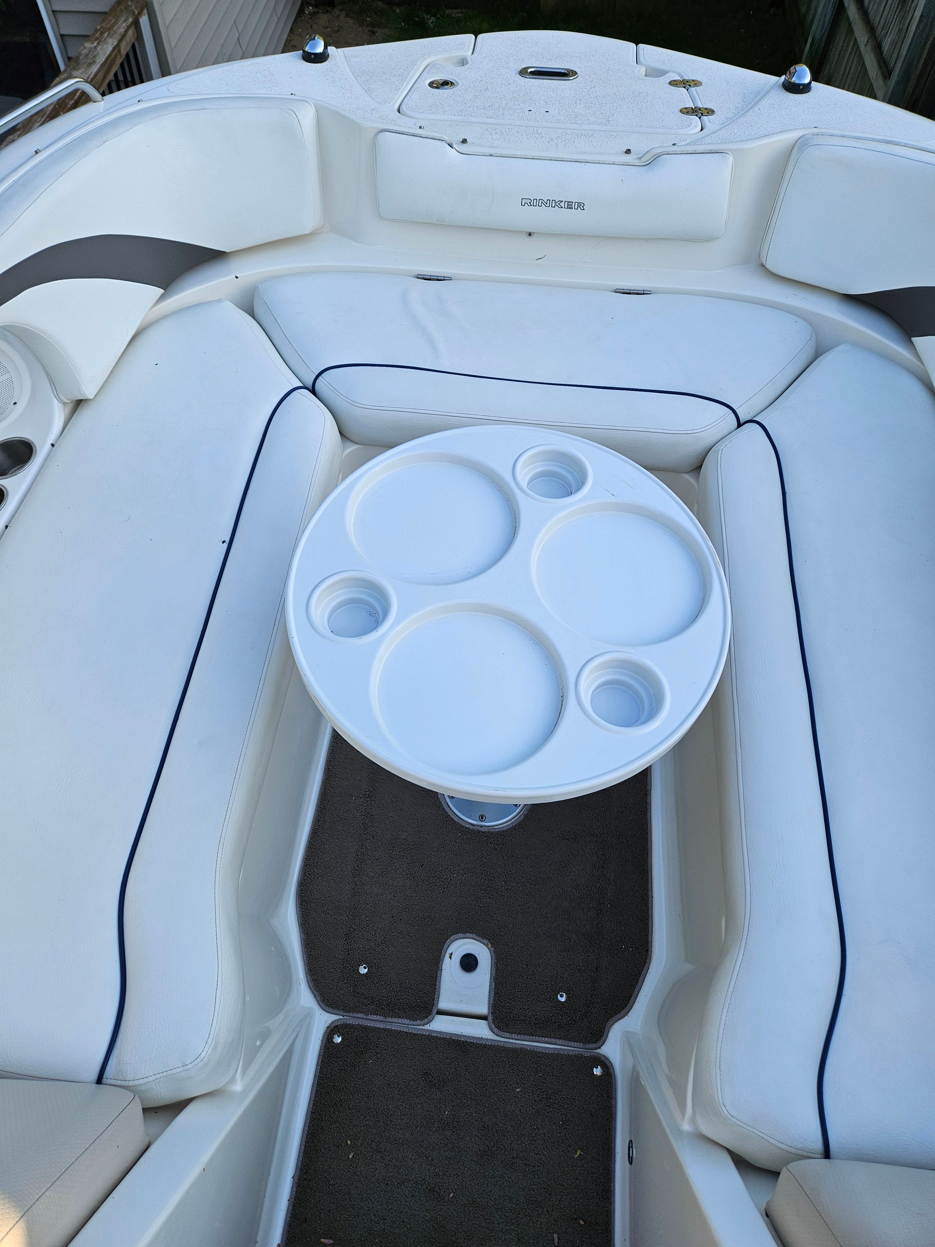 Interior of a 2009 Rinker Captiva DB boat with table.