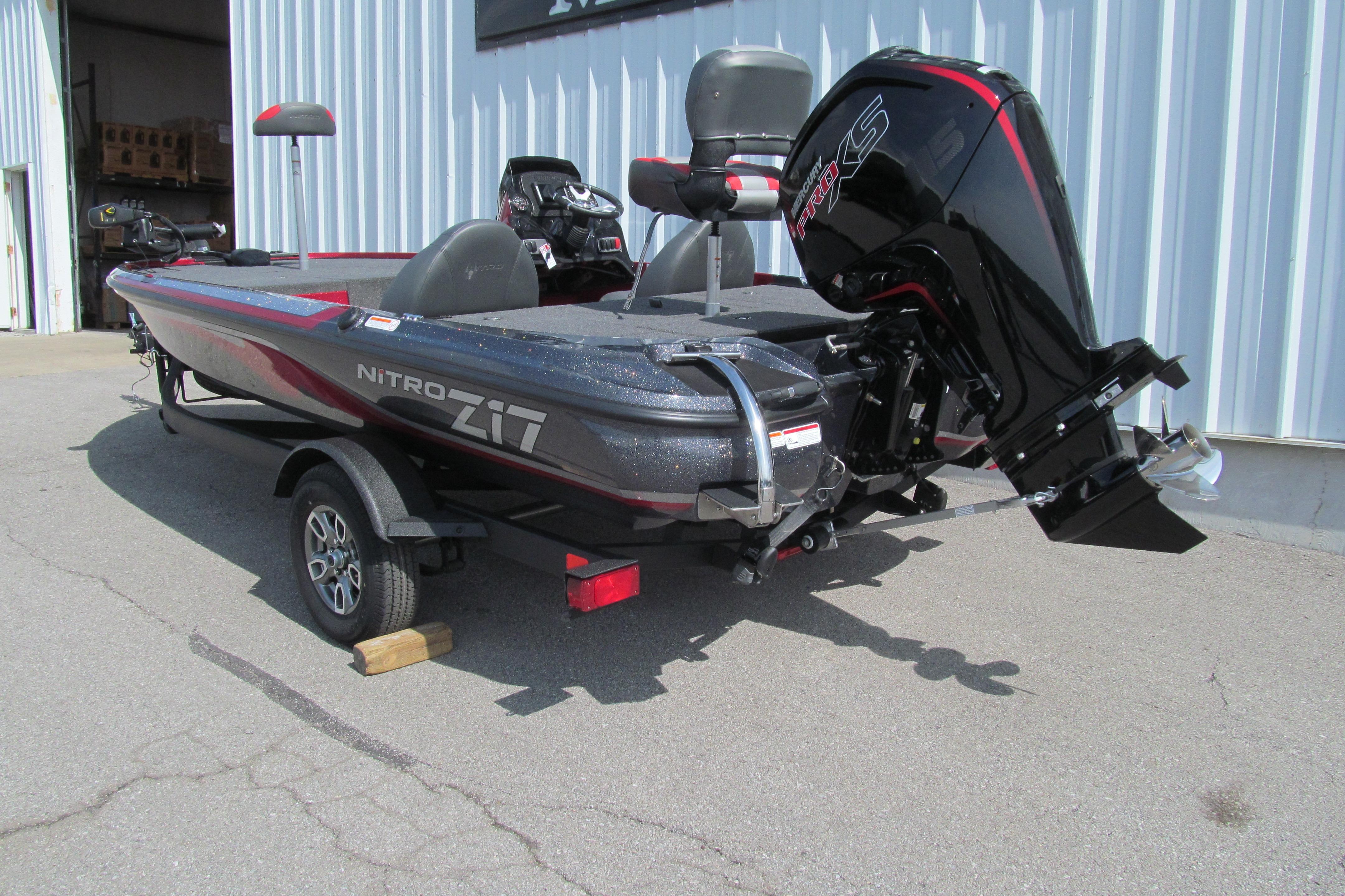 2026 Nitro Z17 boat with powerful outboard motor, parked outside a warehouse.