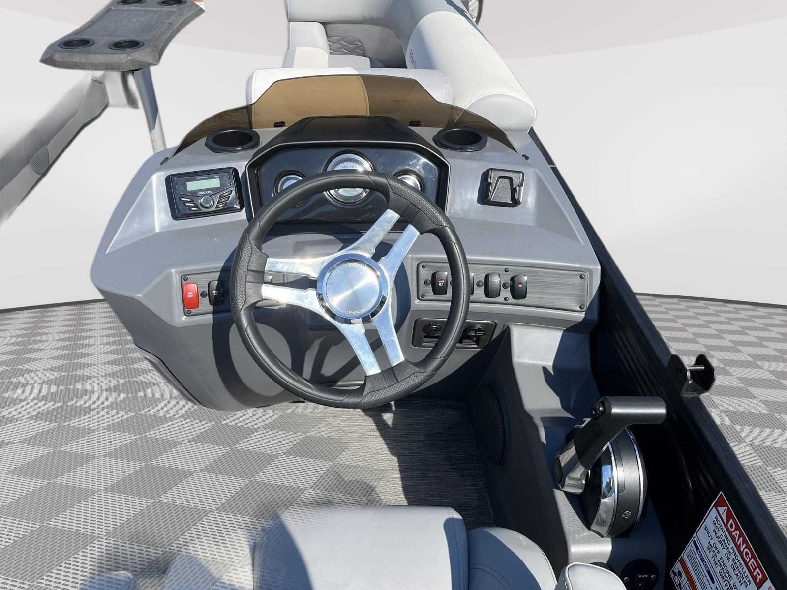 The image shows the helm of a 2025 Bennington S20 with a modern steering wheel and instruments.