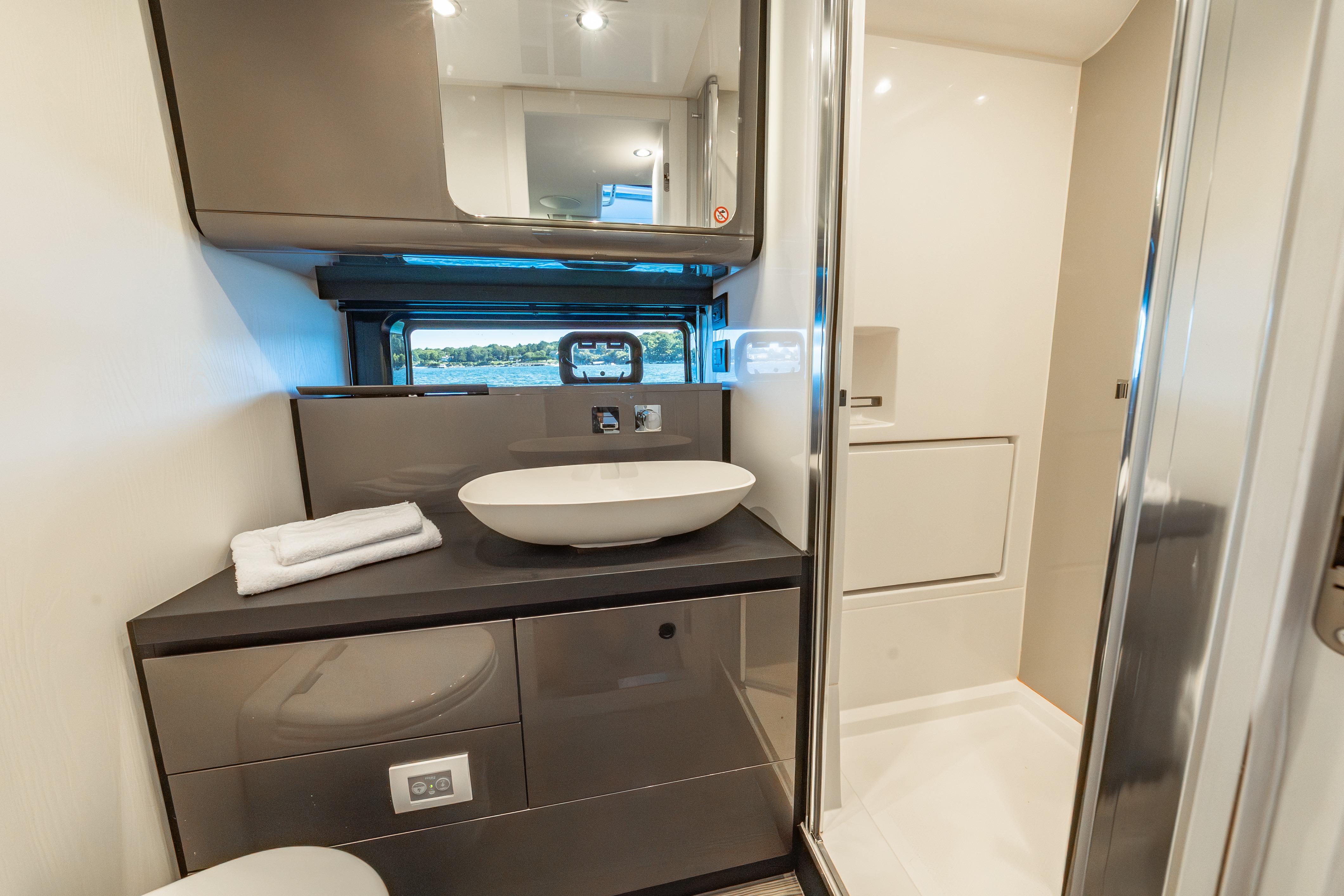 Luxurious bathroom interior of 2023 Azimut Verve 47 yacht with modern fixtures.